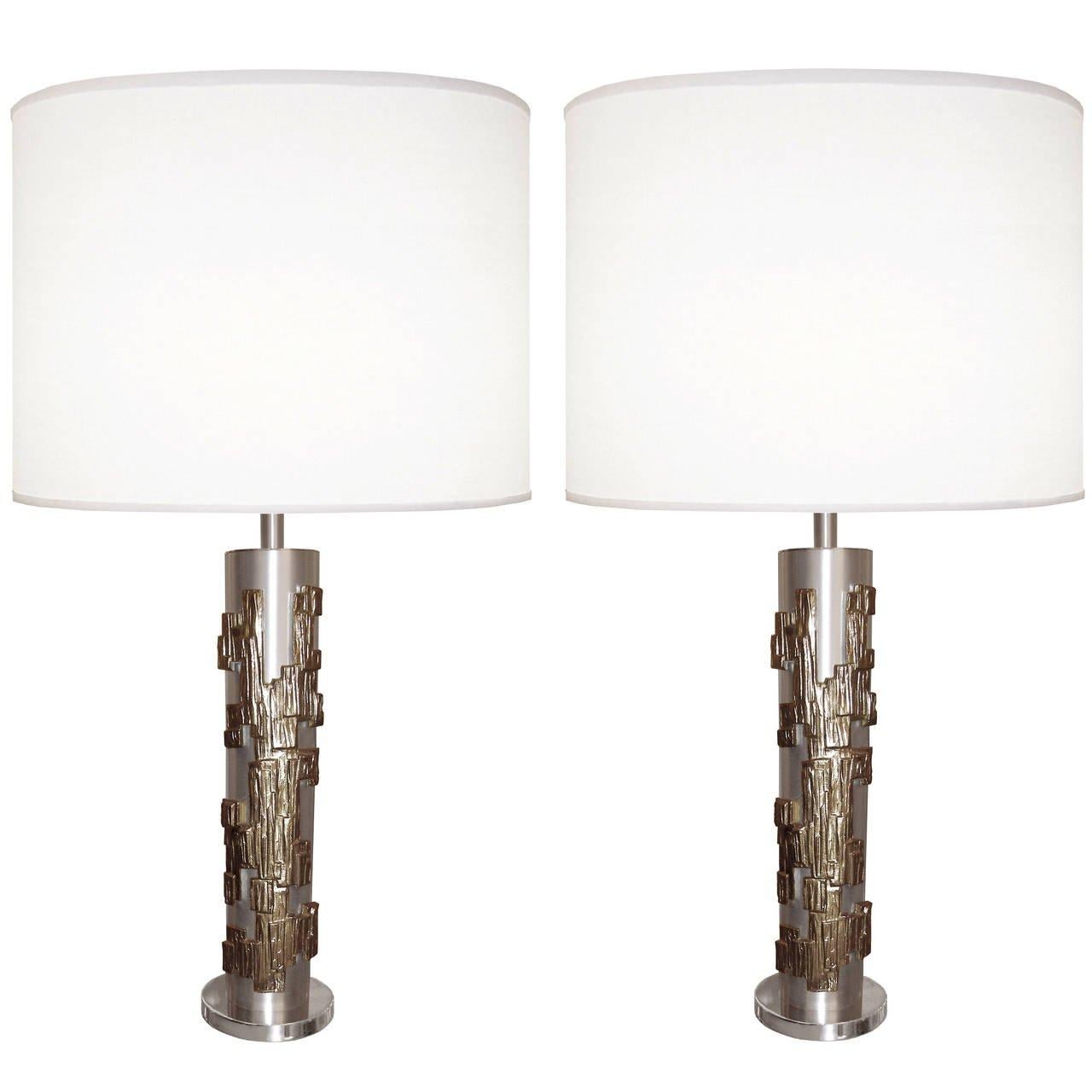 A pair of modernist brushed nickel lamps with sculptural bronze overlay.

circa 1970s

Lamp shades are not included.

Lamp shades are available in: White or Ecru Linen Color.


  