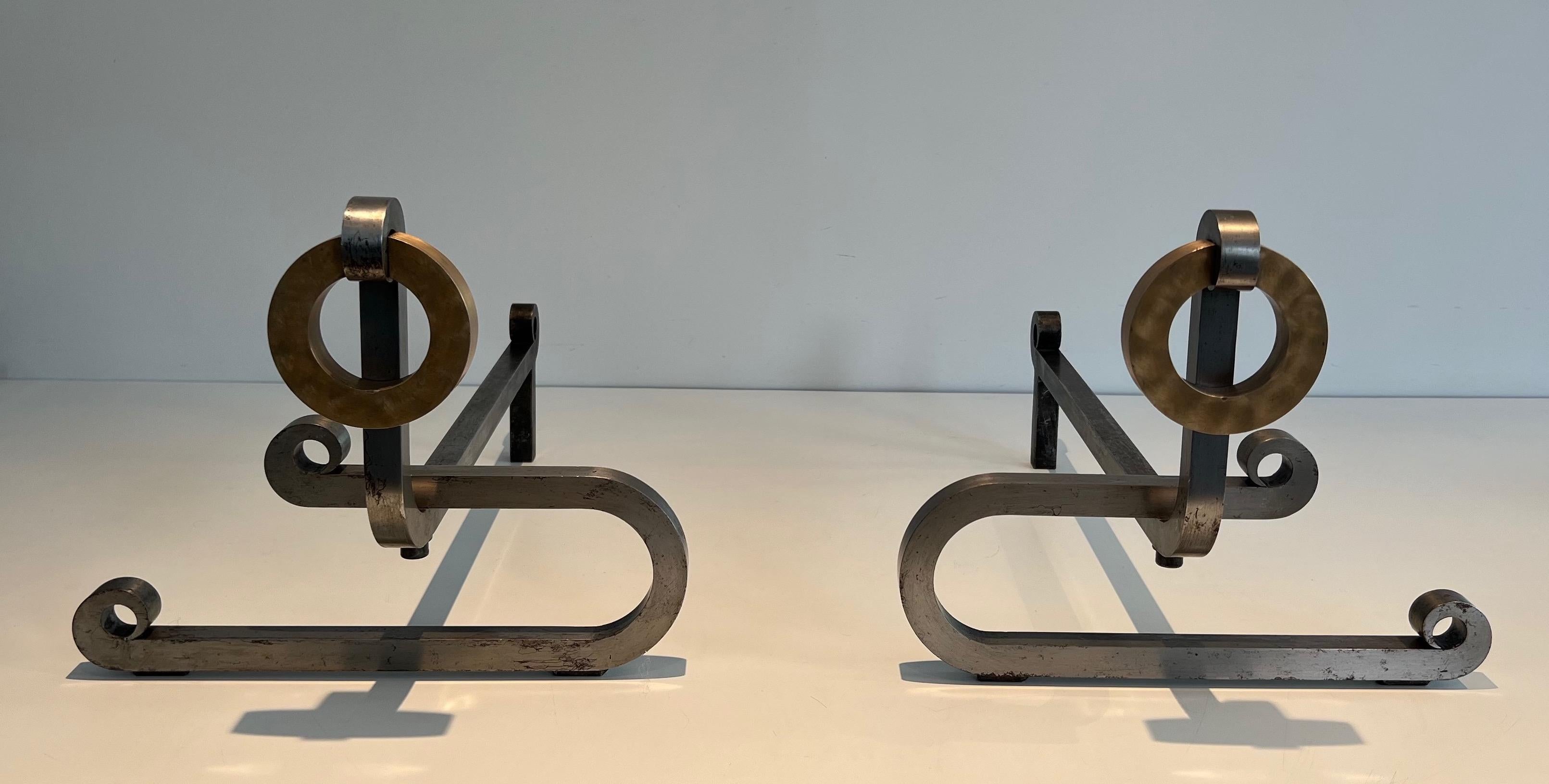 This pair of modernist andirons is made of brushed steel, brass and iron. This is a very nice model, large and made of very good quality. This is a French work. circa 1970
