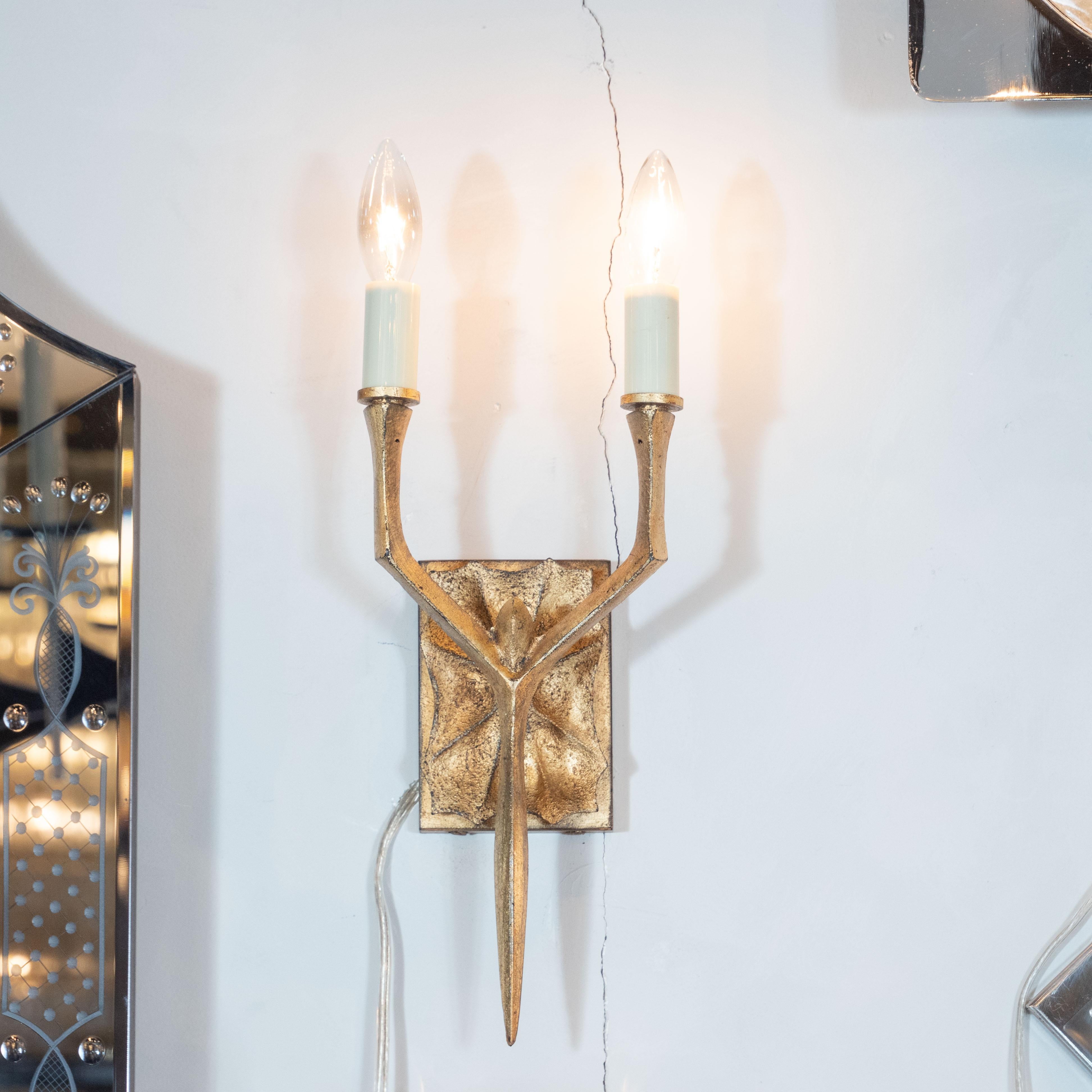 This dramatic and elegant pair of modernist brutalist branch sconces feature two arms; a rectangular backplate with a hand carved texture; and two arms resembling tree branches that meet in the center and converge to a single point. The 24-karat