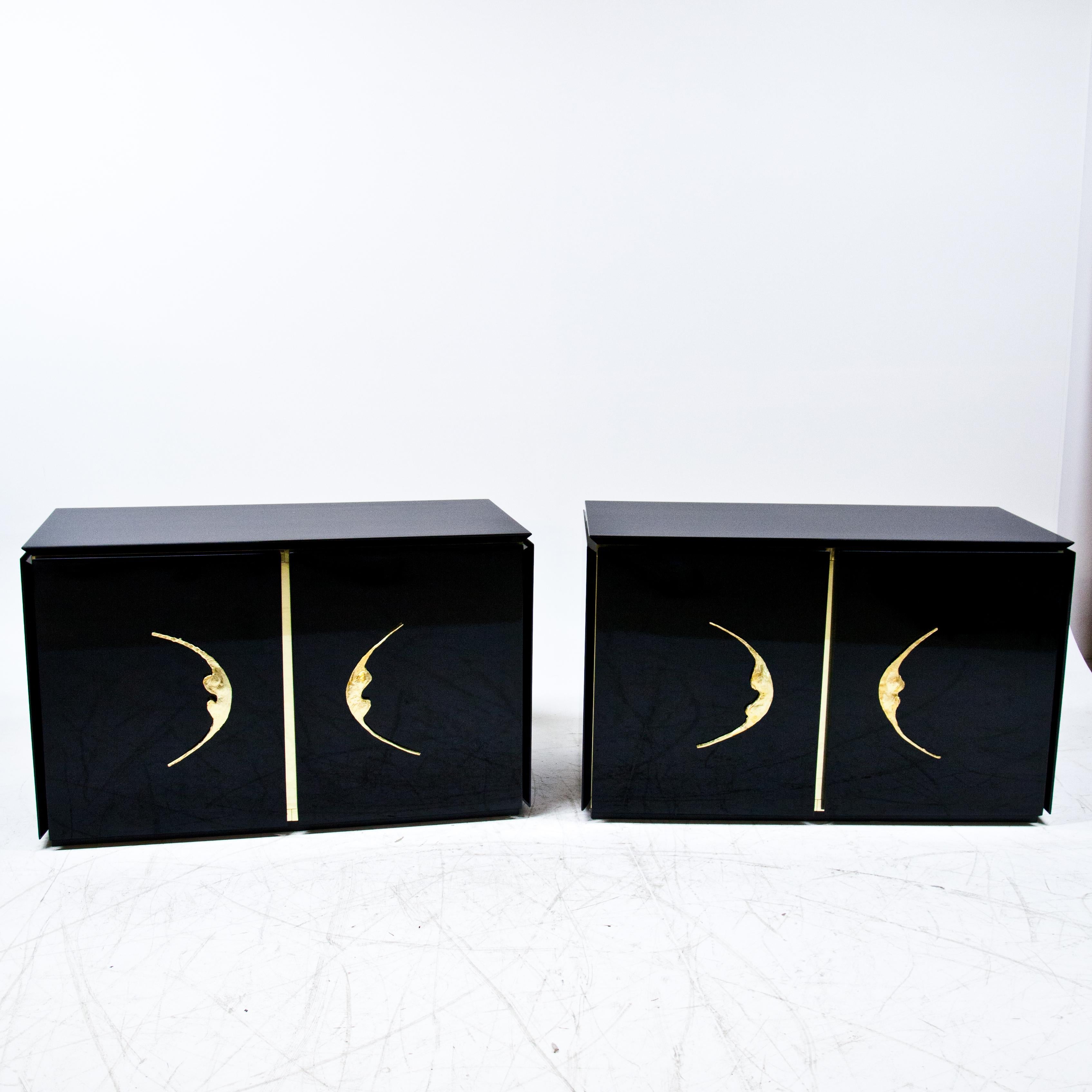Pair of Modernist cabinets in black lacquer with bronze abstract pulls.