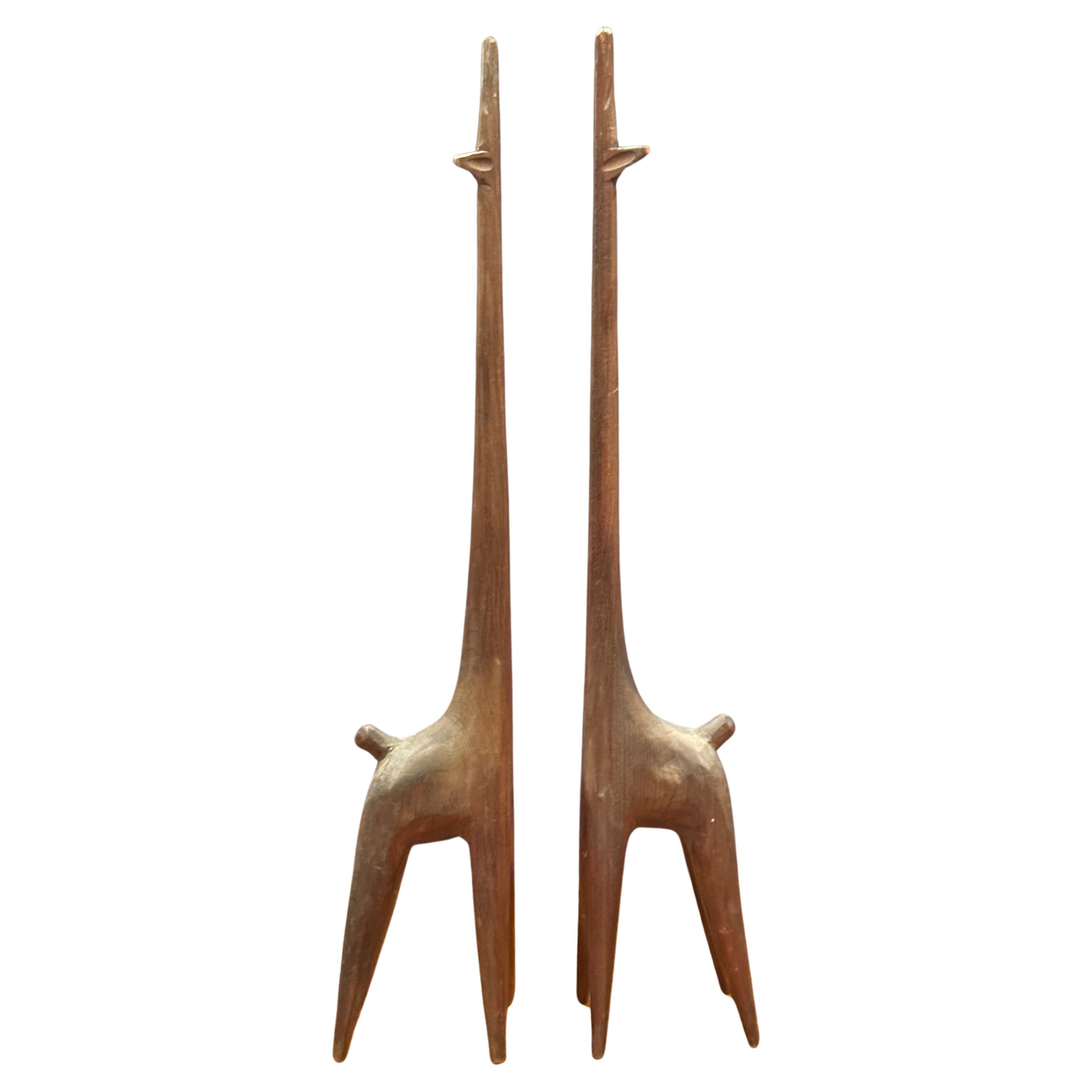 Super cool pair of modernist giraffe carved wood (walnut?) sculptures, circa 1960s. The sculptures are hand carved and measures: 2