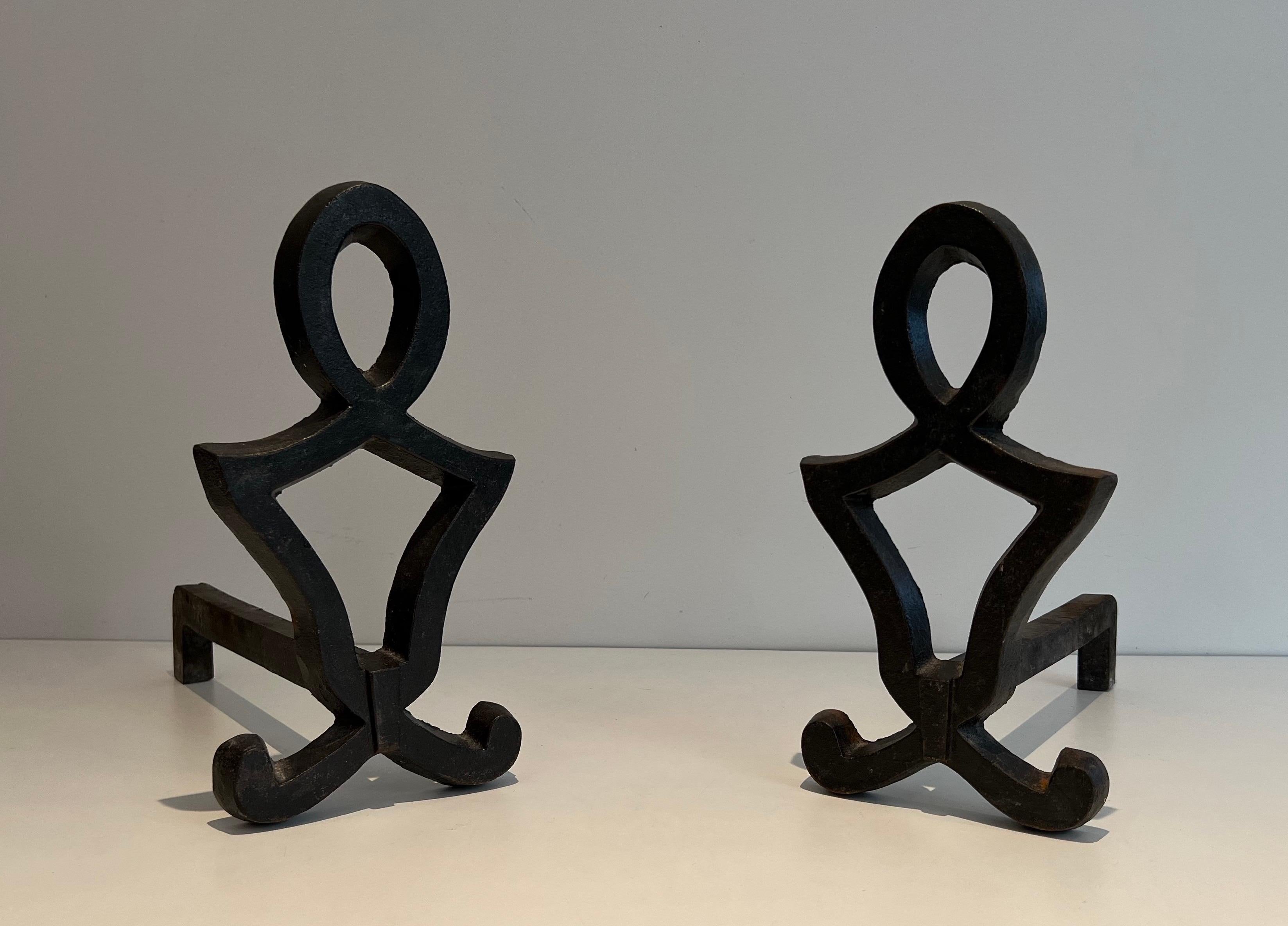 This pair of modernist andirons is made of cast iron and wrought iron. This is a French work by Raymond Subes. Circa 1940