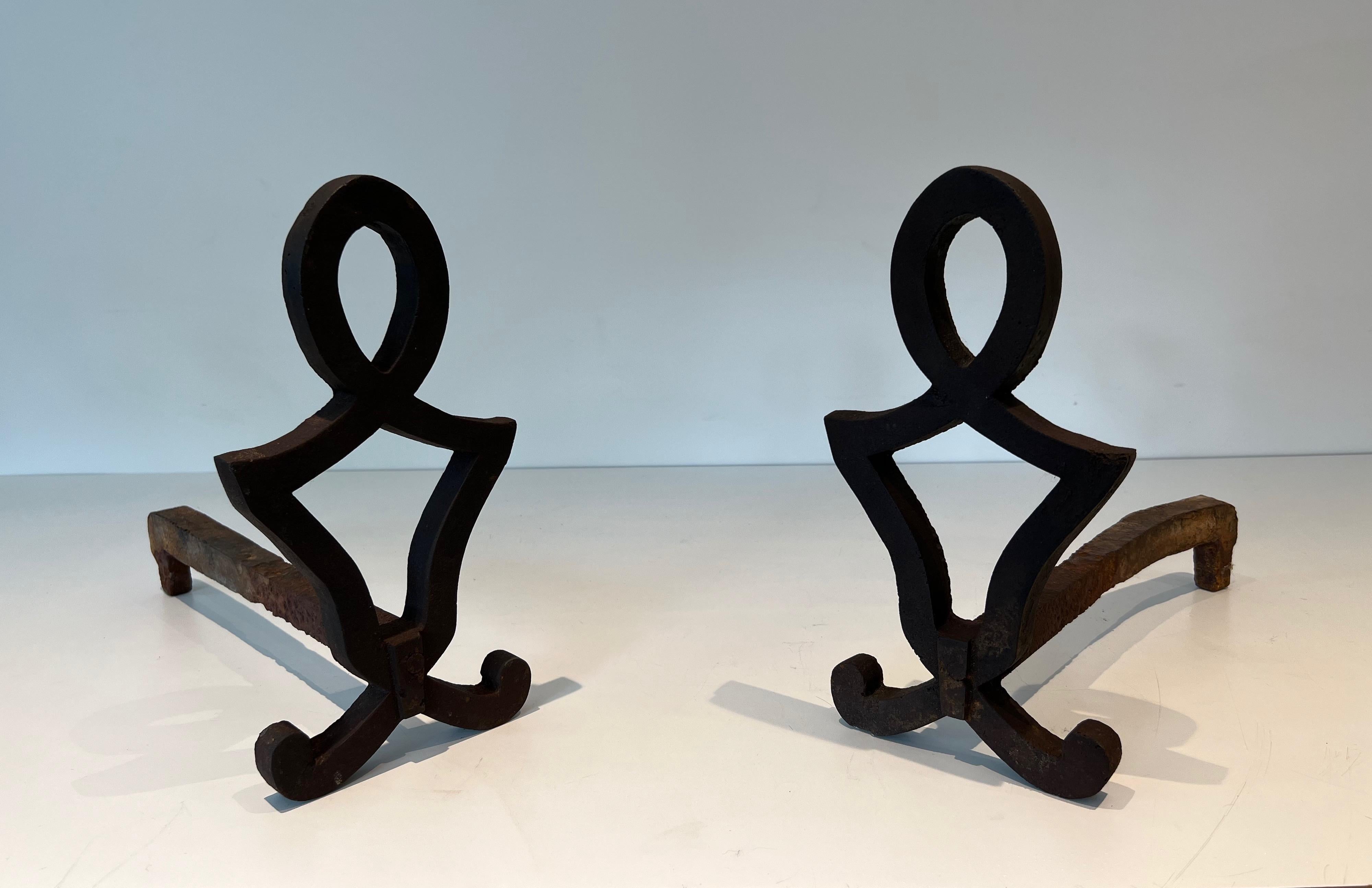 This very nice pair of modernist andirons is made of cast iron and wrought iron. This is a French work by Raymond Subes. Circa 1940