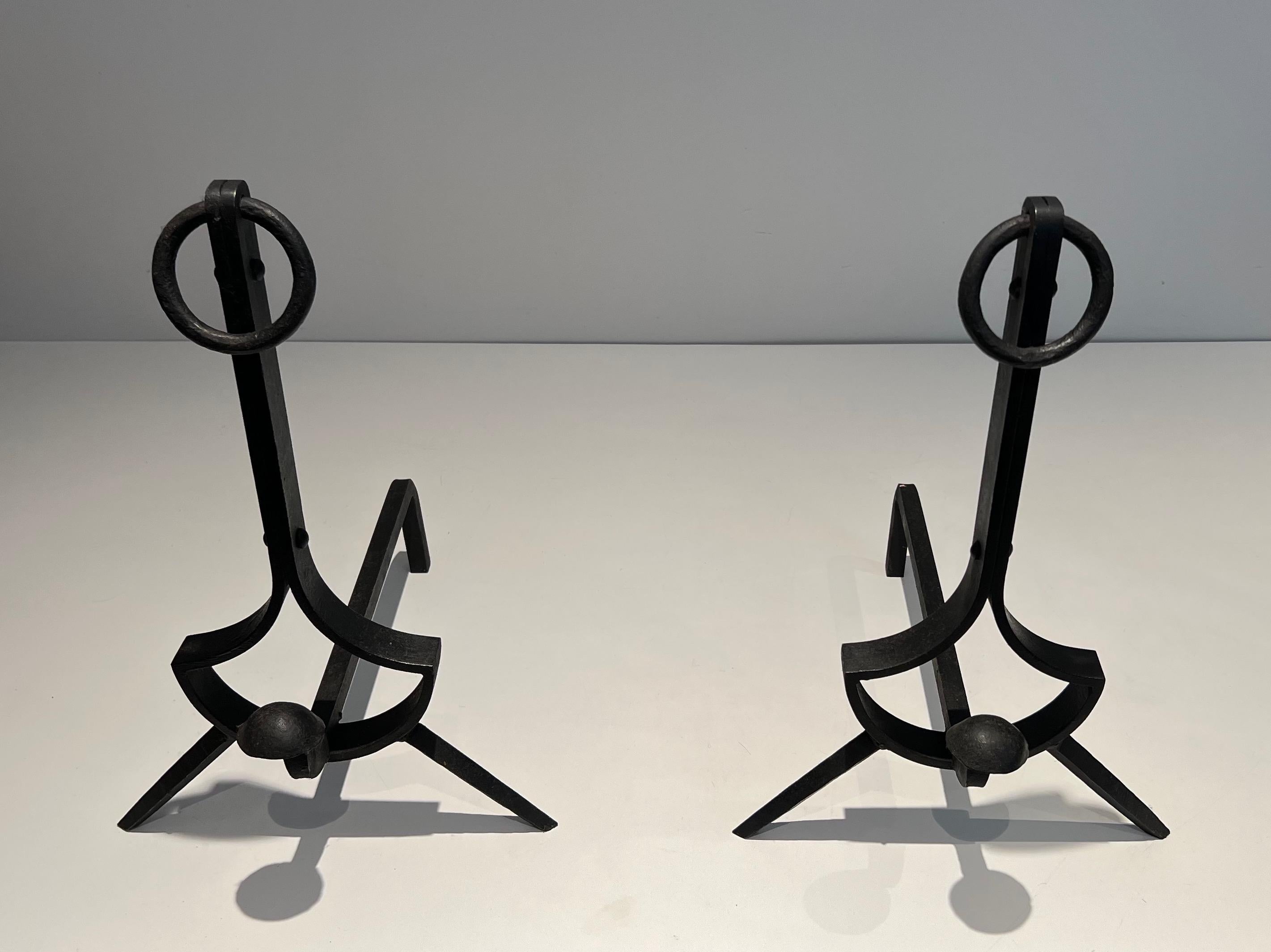This pair of modernist andirons is made of wrought iron. This is a French work, circa 1940.