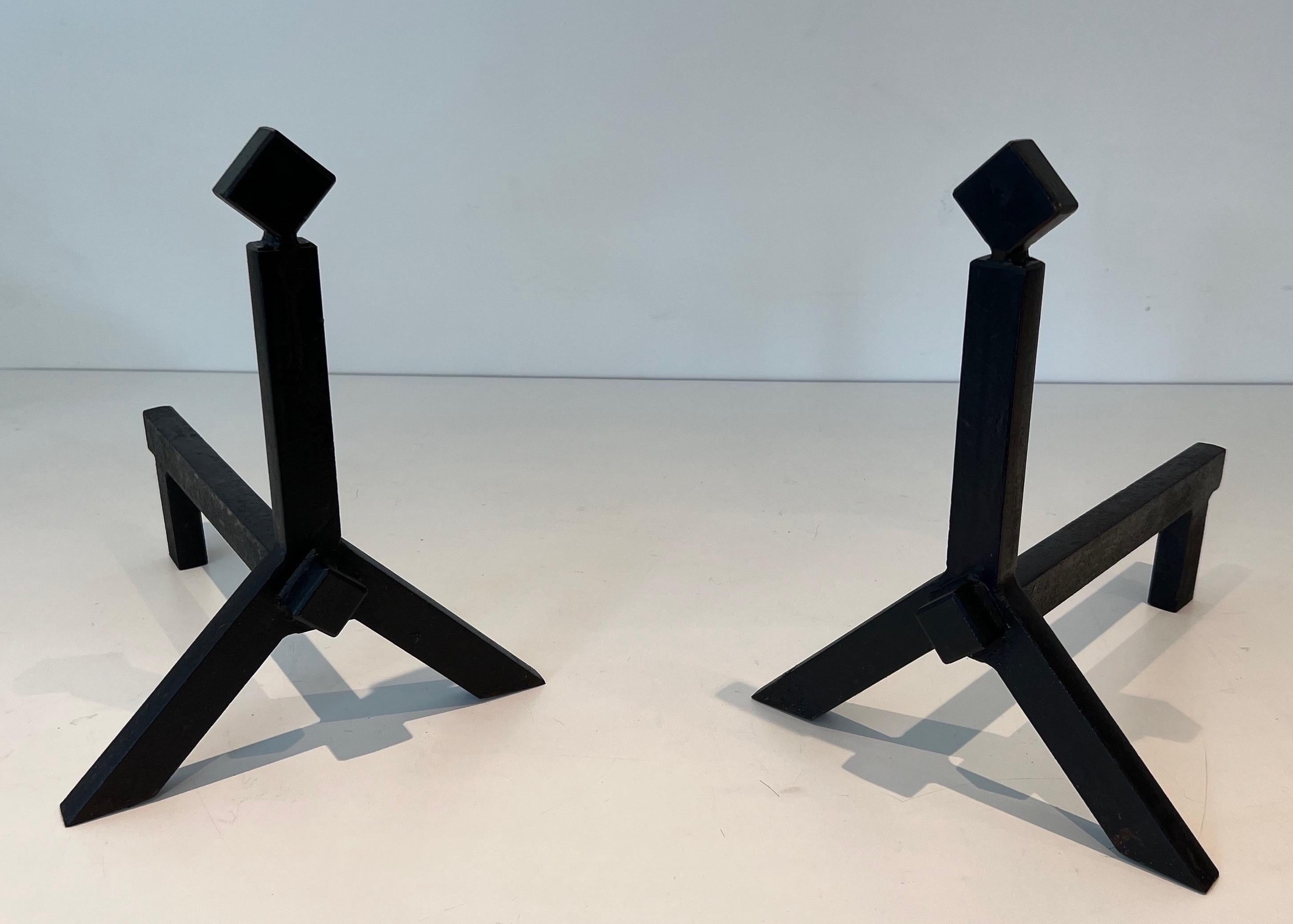 This very nice pair of modernist andirons is made of wrought iron. This is a French work. Circa 1950