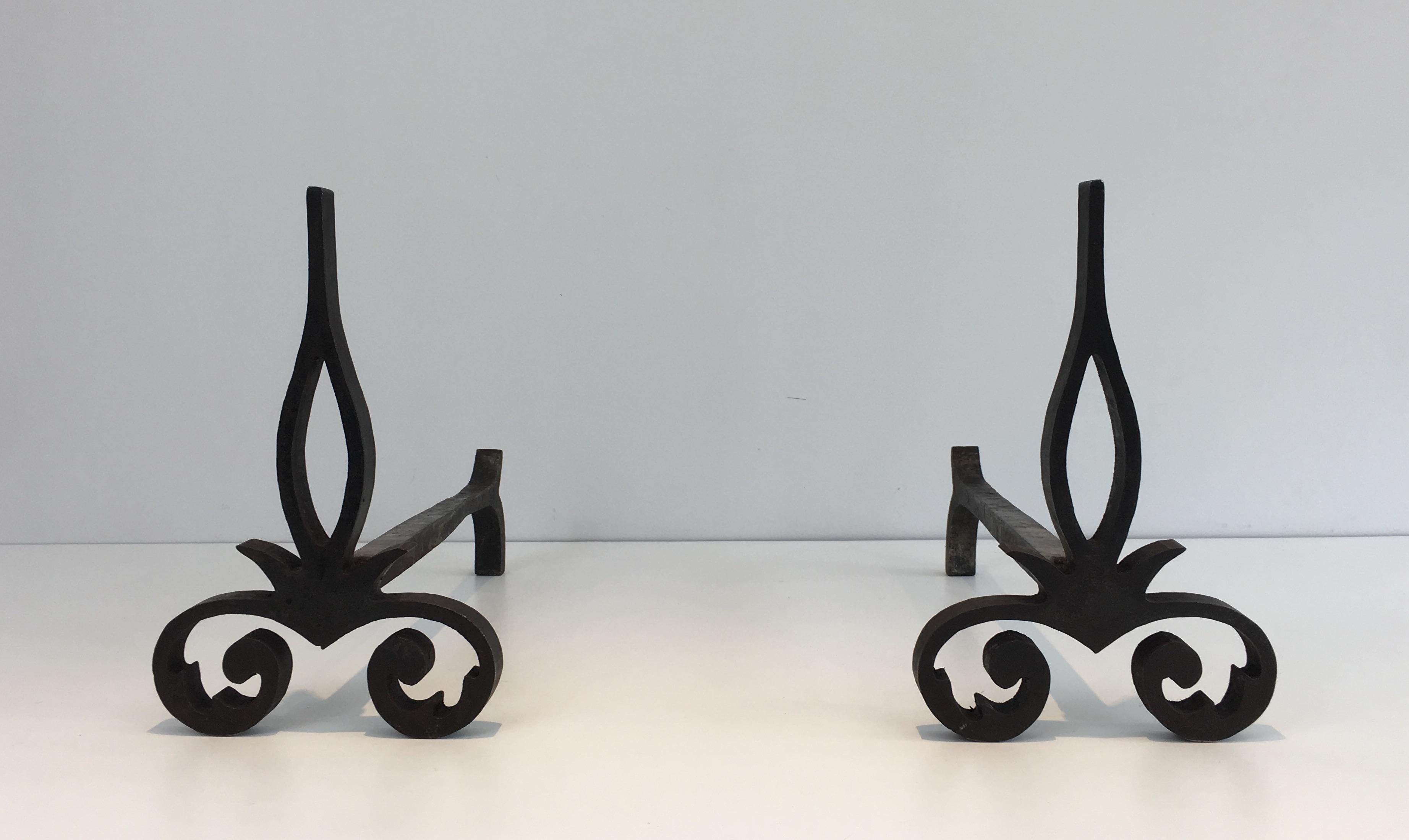 This pair of andirons are made of cast iron and iron. They are modernist, simple and strong. They are French, circa 1940.