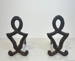 Pair of modernist cast iron and wrought iron andirons. French work by Raymond Su