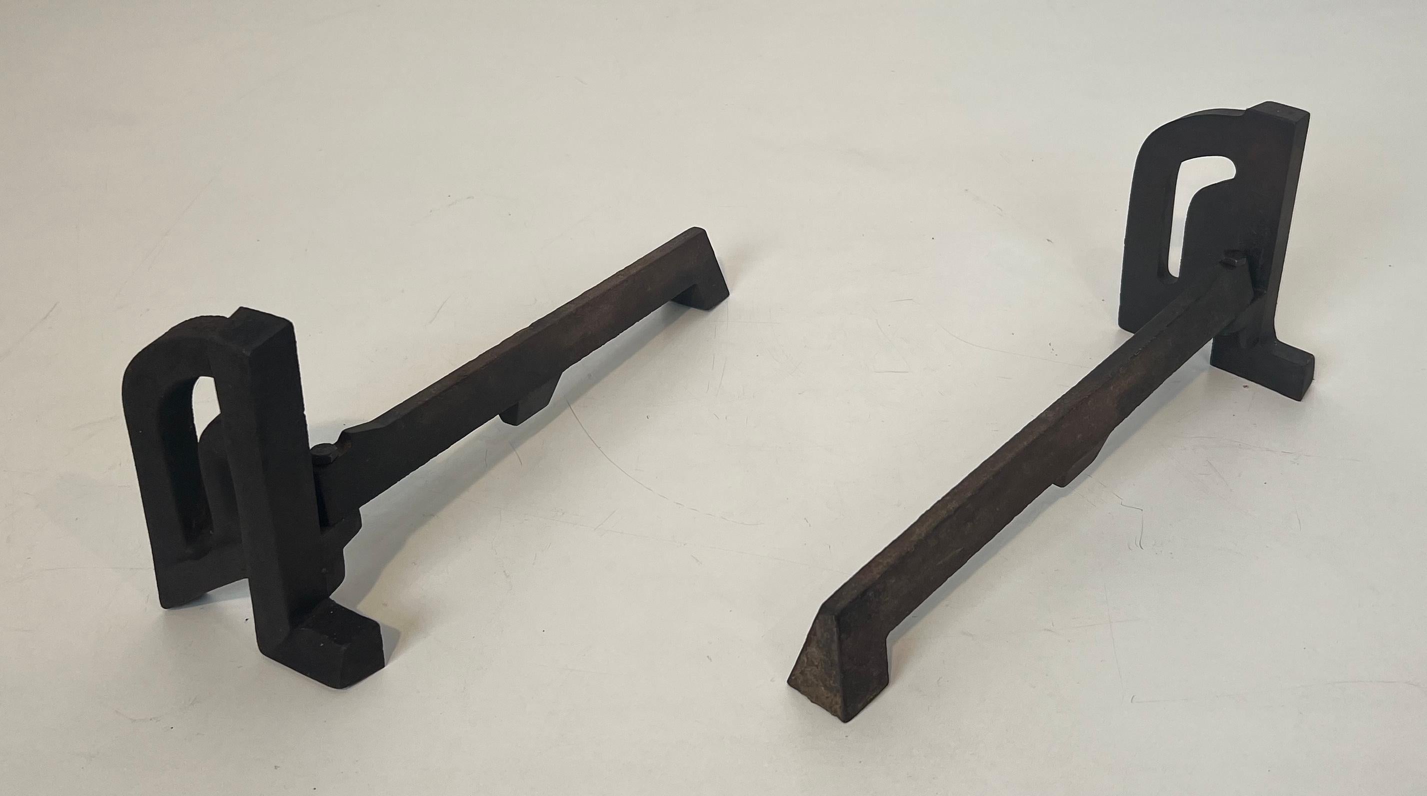 Iron Pair of modernist cast iron and wrought iron andirons. French work. Circa 1940 For Sale