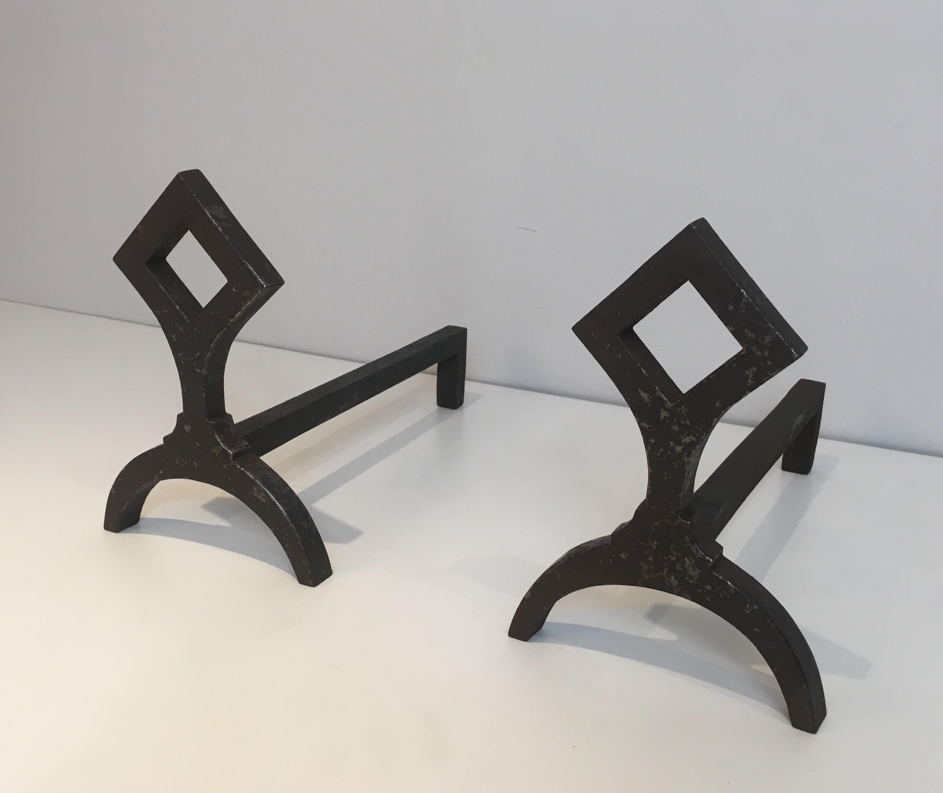 This nice pair of modernist fire place andirons is made of cast iron. This is a French work, circa 1950.