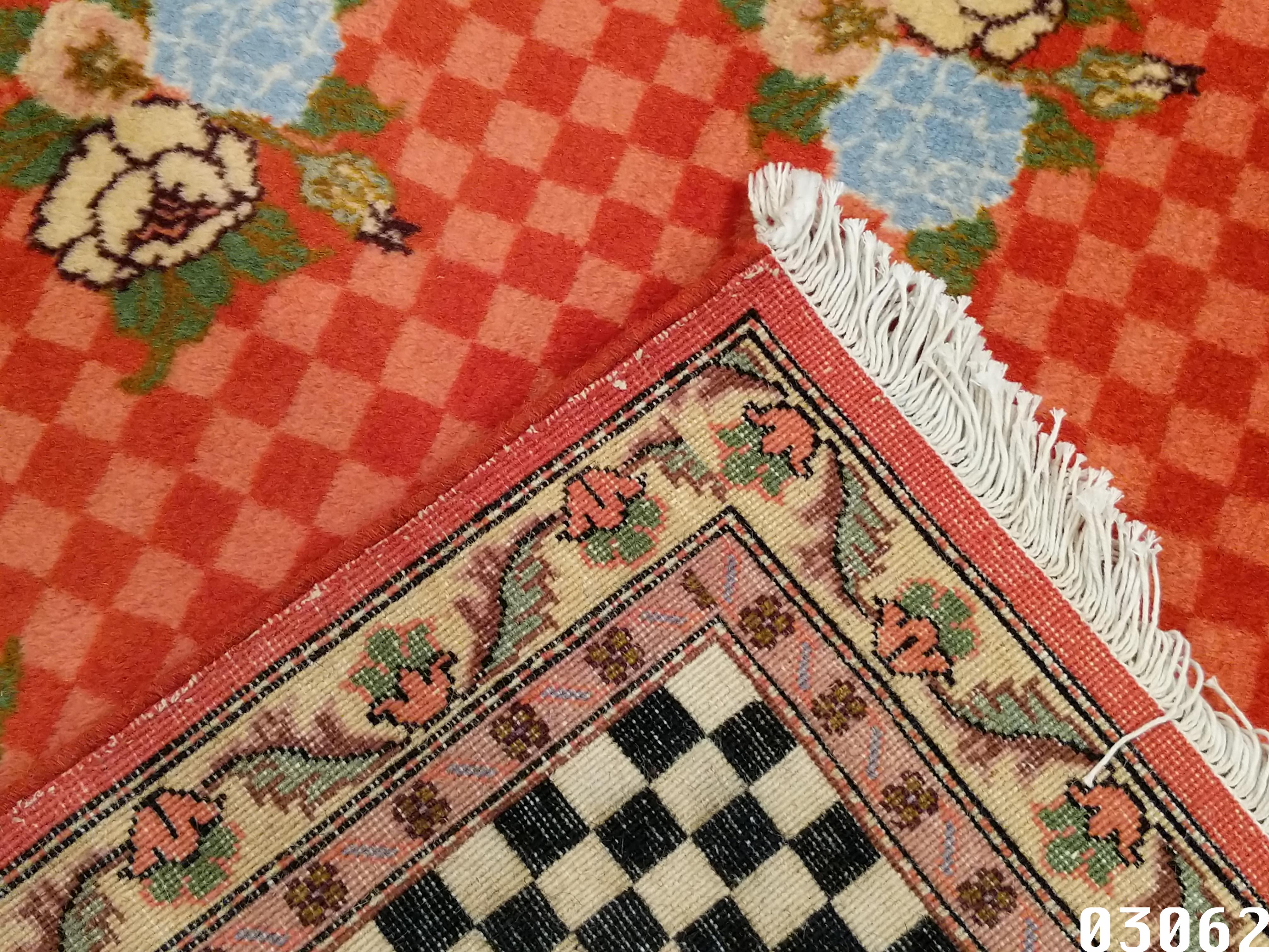 A rare and highly unusual pair of Modernist Indian rugs characterized by a chequerboard design background in red and rose onto which is laid an all-over repeat pattern composed of a bouquet of roses in different colours. The ivory and black