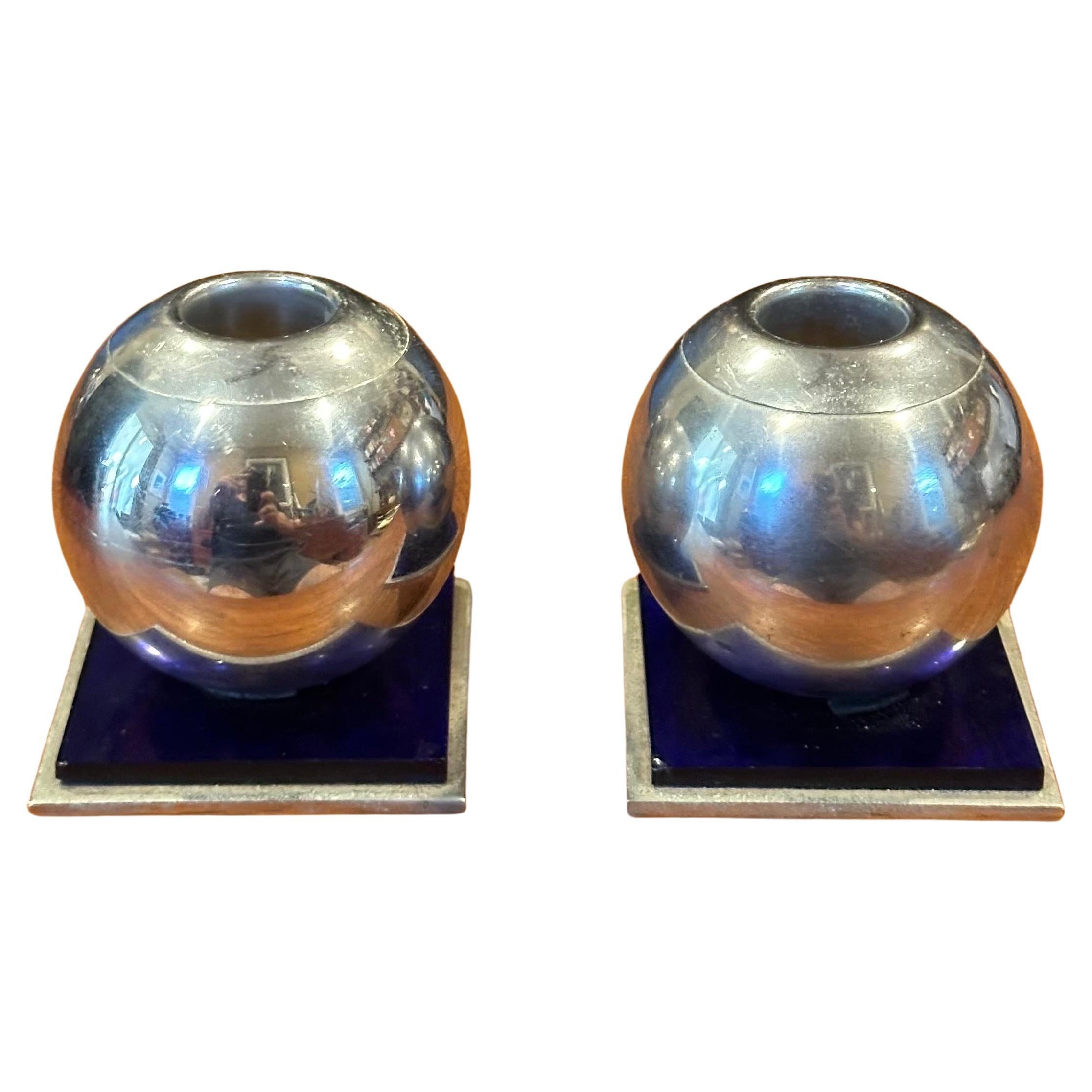 A very nice pair of modernist chrome and cobalt candle holders by Chase & Co., circa 1940s. The chrome design features a 2.5