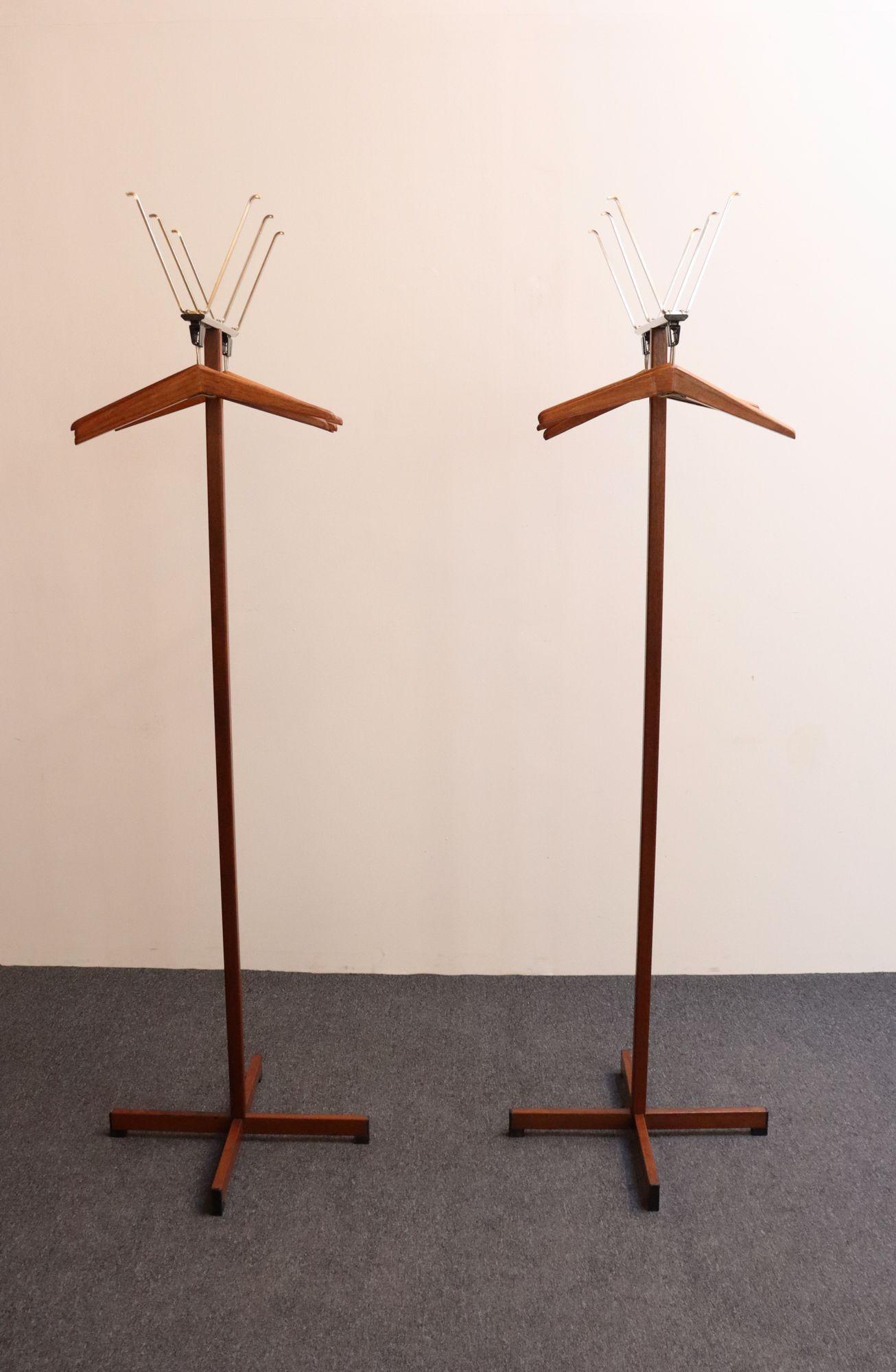 Pair of Mid-Century Modern coat/hat trees manufactured by Vogel-Peterson (ca. 1960s, Illinois, USA).
One rack/tree is equipped with five removable walnut hangers; the other has six, and both racks feature three 