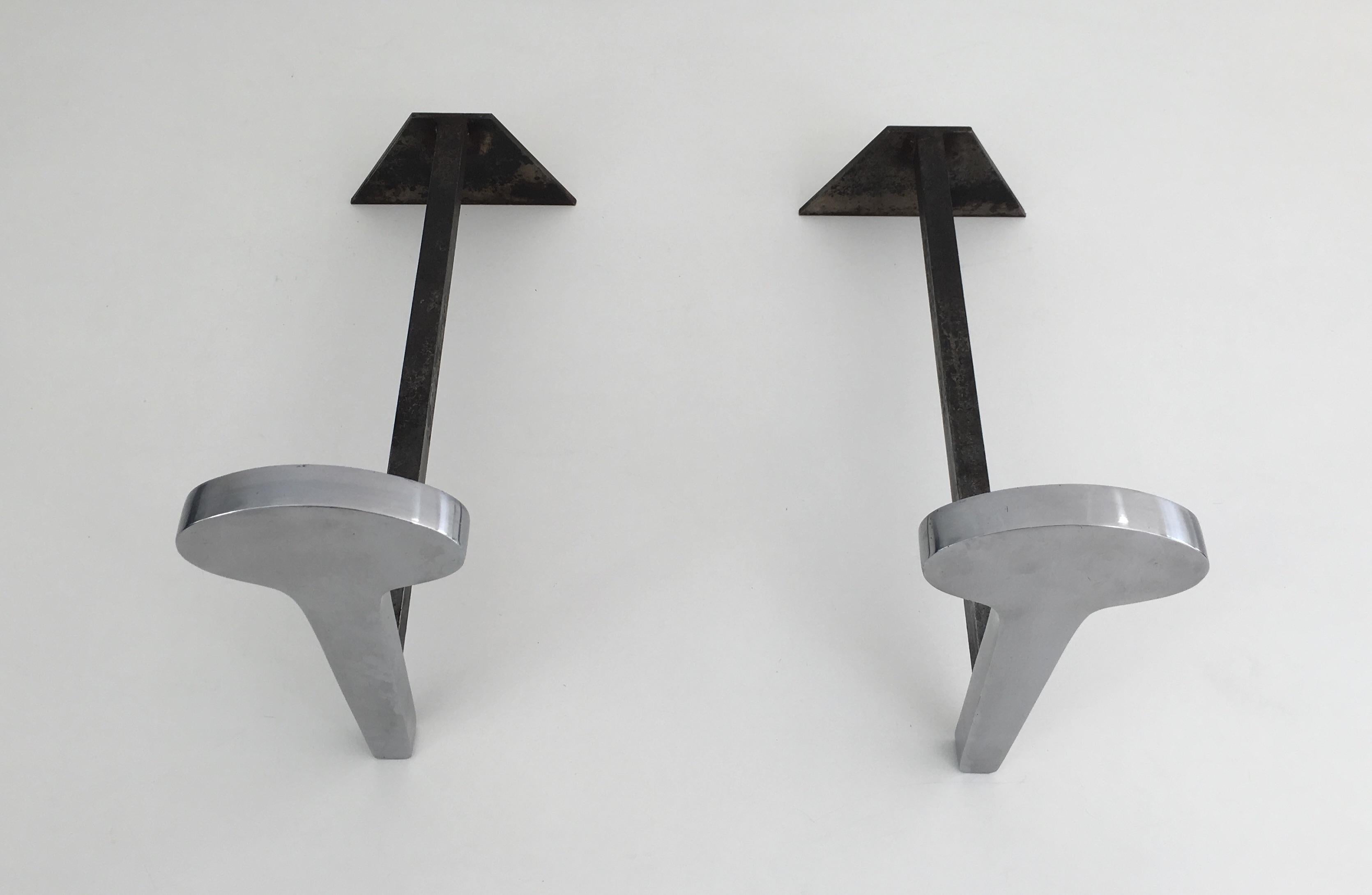 This beautiful pair of modernist andirons are made of chromed steel and Iron. This is a French work, circa 1970.