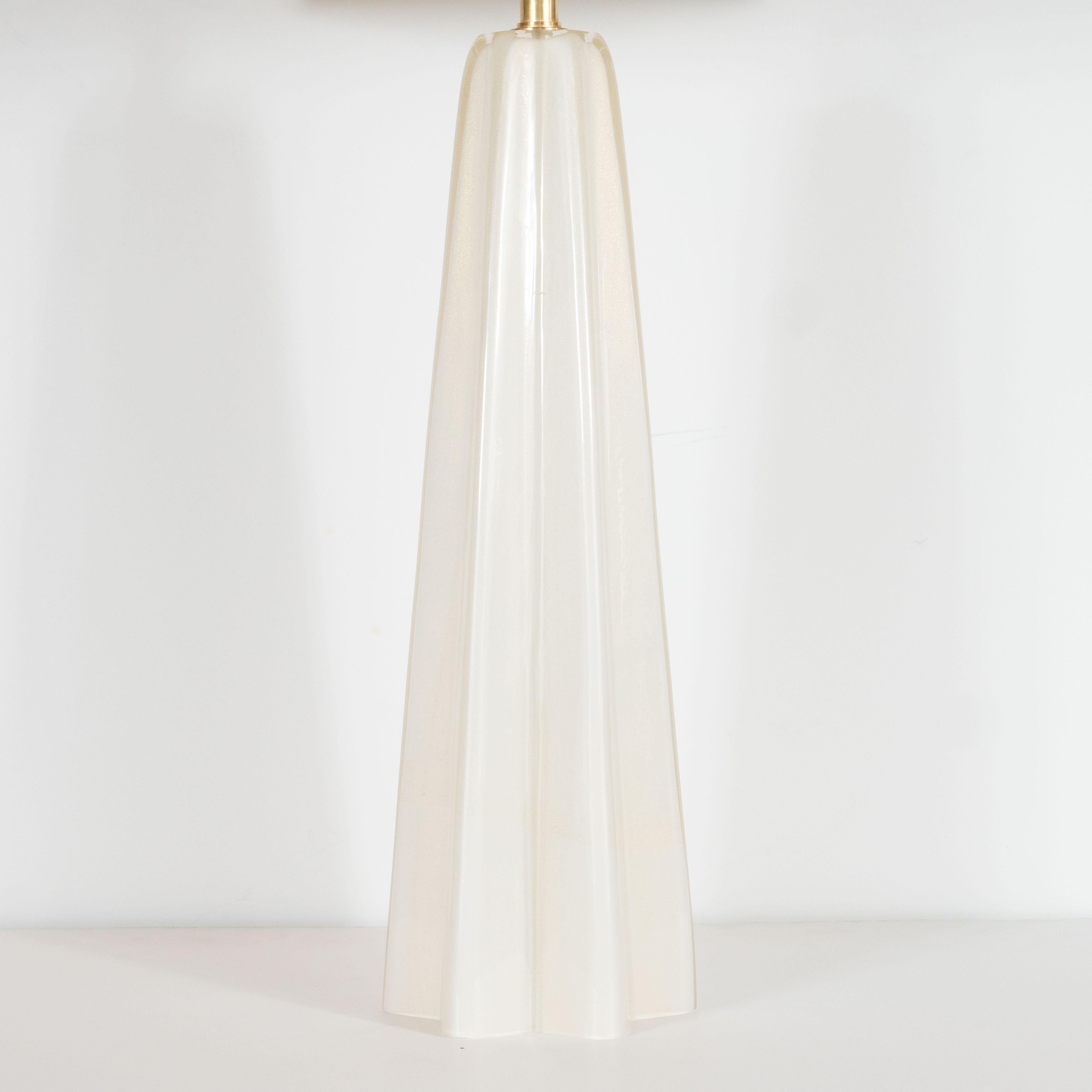 This elegant pair of table lamps were hand blown in Murano, Italy- the island off the coast of Venice renowned for centuries for its superlative glass production. They feature tapered stylized x-form bodies with subtly concave sides that connect the