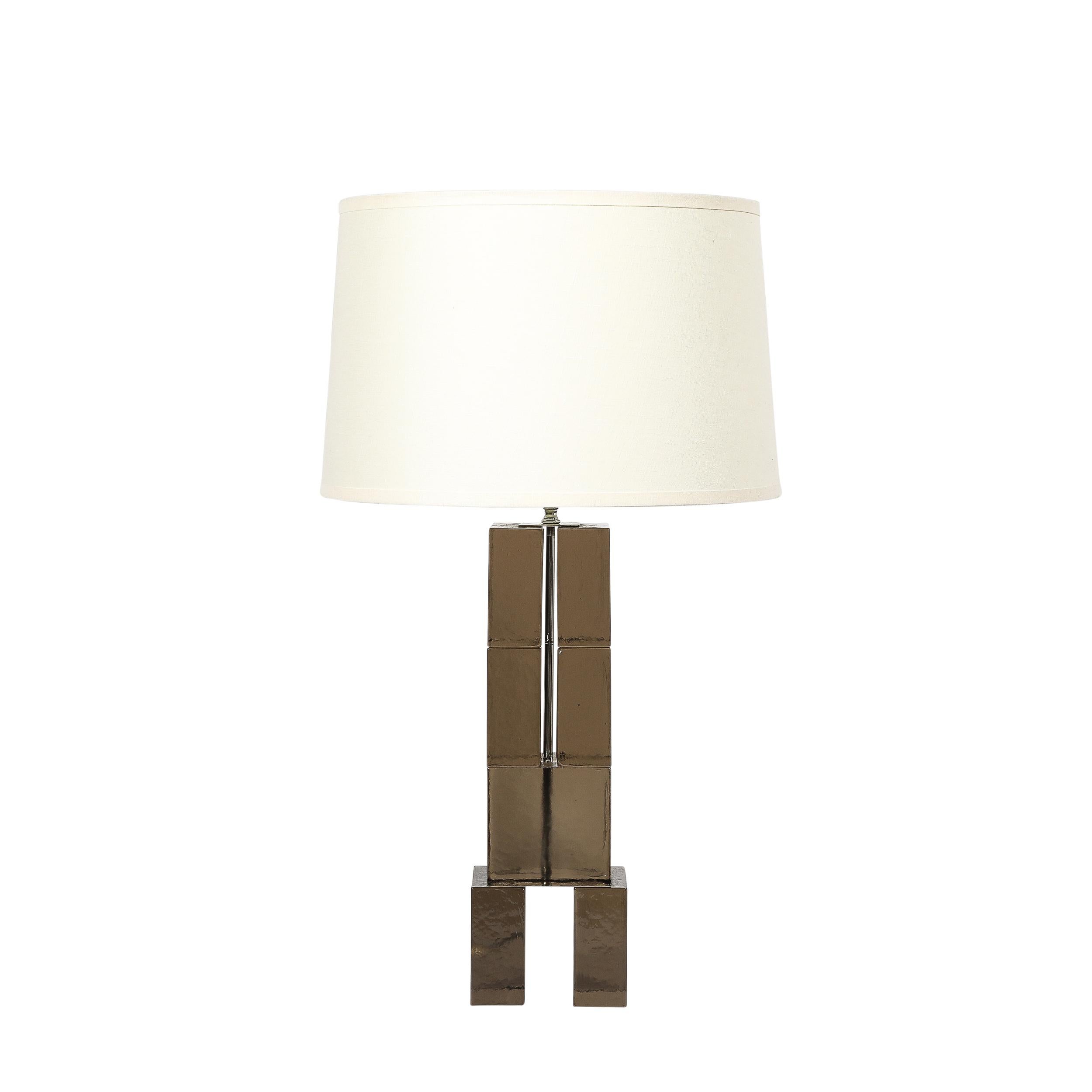 This pair of refined modernist table lamps were hand blown in Murano, Italy- the island off the coast of Venice renowned for centuries for its superlative glass production. It features smoked glass volumetric rectangular forms- offering a subtle