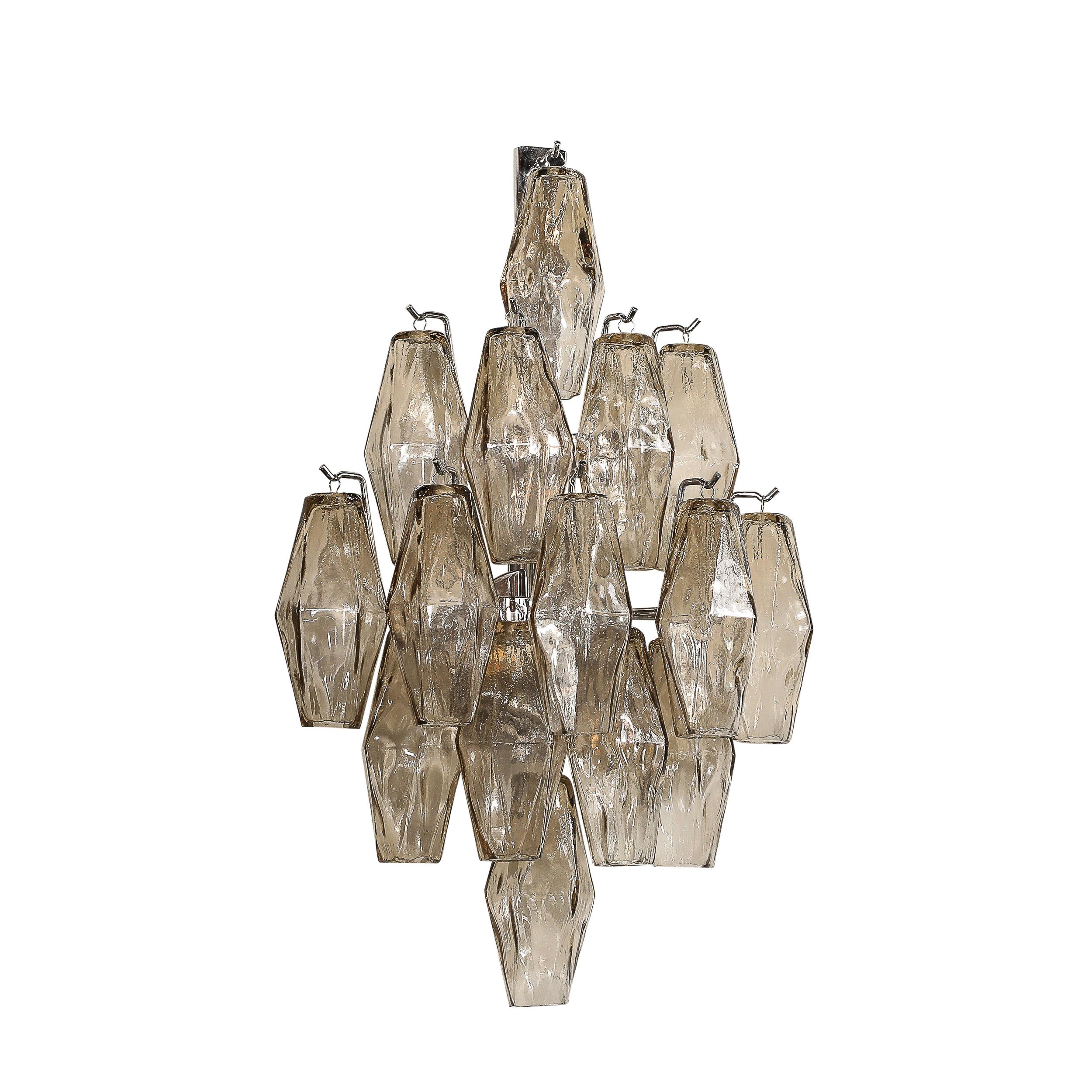 This beautifully elegant Pair of Modernist Hand-Blown Smoked Murano Glass Diamond Form Polyhedral Sconces with Chrome Fittings originates from Italy during the later half of the 20th Century. They feature a geometric composition of transparent