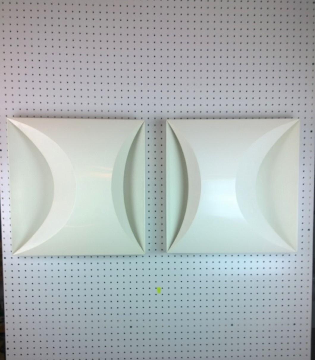 Offered are a pair of modernist later 20th century modern square white sconces by RAAK of Amsterdam. This pair can also be used a flush mount lighting. This truly mod pair almost look like the Couregges' logo. The pair would look fabulous on each