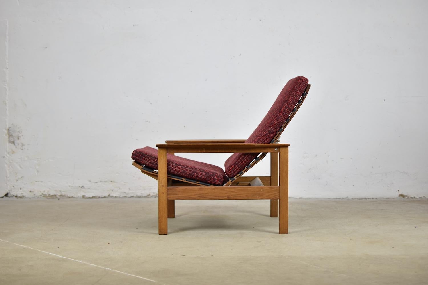 Rare pair of modernist lounge chairs by Georges Vanrijk for Beaufort, Belgium, 1960s. This set is made out of oak and fabric. The construction of the chairs allows for a slight rocking motion if wanted. They are extremely comfortable and beautiful
