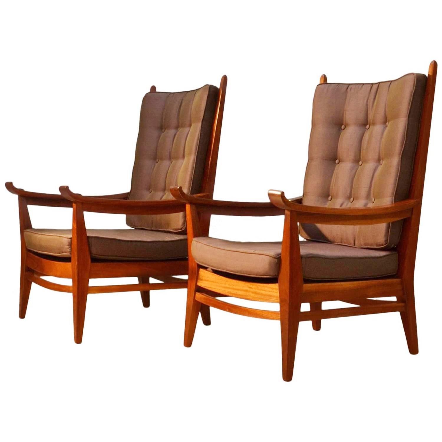 Oak wooden framed handcrafted high back slatted chairs with real character. The button cushioned seats and backs are re upholstered in a warm tone high quality silk that matches well with the orange brown wood. The throne like chairs arm rests curve