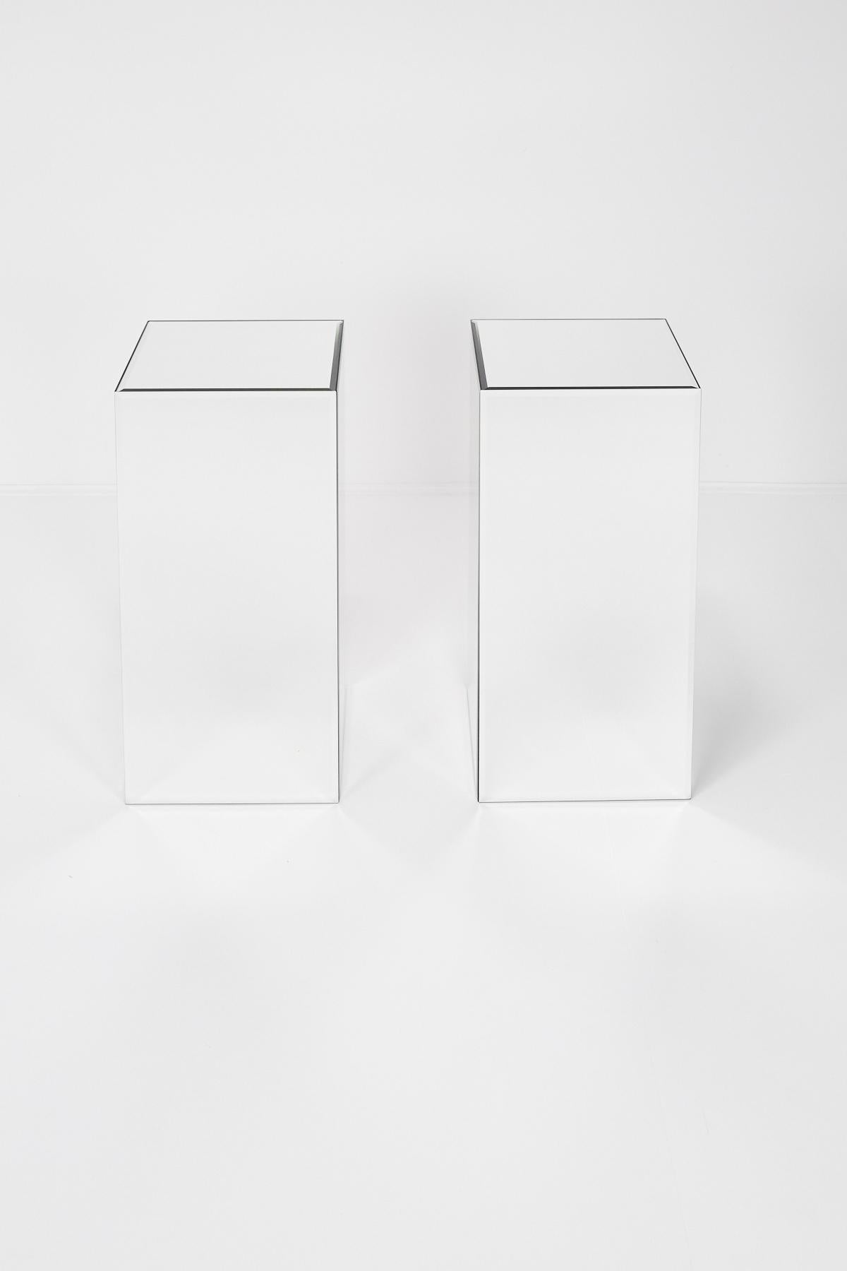 Versatile pair of fully mirrored pedestals. Flip them over to reveal an 8 in. deep fully mirrored recess that could function as a plant stand. All edges are beveled. Beautifully made and in excellent condition.