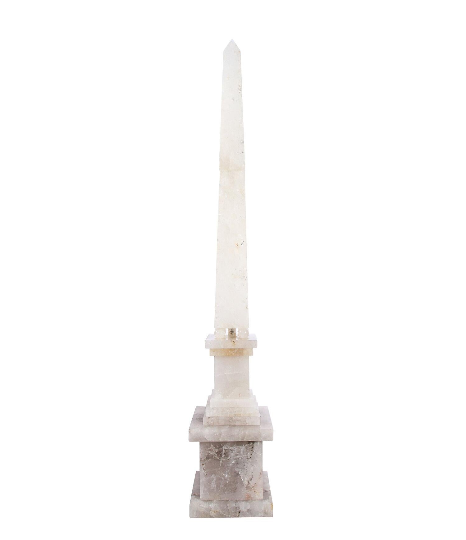 This stunning pair of monumental modernist hand carved rock crystal obelisks were realized in Brazil- renowned for its glorious abundance of precious and semi-precious stones- during the 20th century. They offer faceted tapered bodies that ascend to