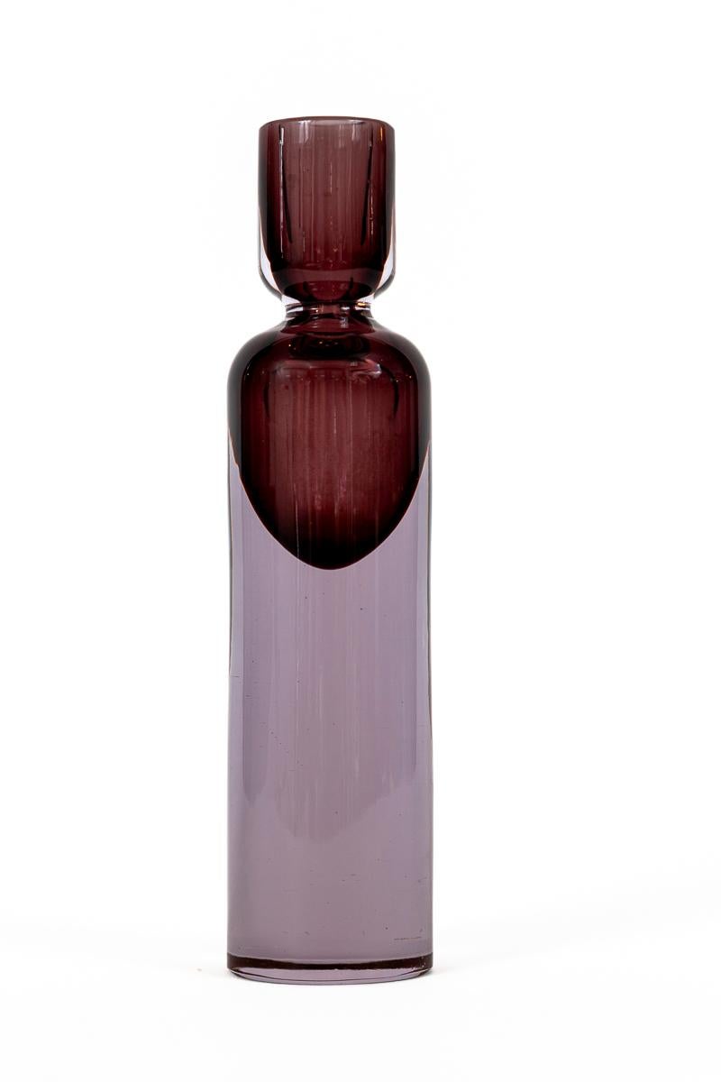 A pair of unique Modernist candle holders blown in the sommerso technique with plum colored glass suspended over transparent clear glass by designer Antonio Da Ros for Cenedese

Origin: Murano, Italy

Dating: 1960

Condition: Excellent

Dimensions: