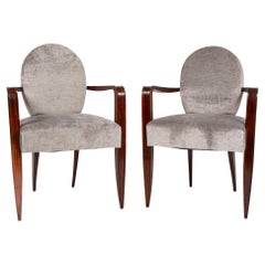 Paire de fauteuils modernistes à dossier ovale en acajou africain par Jean Pascaud