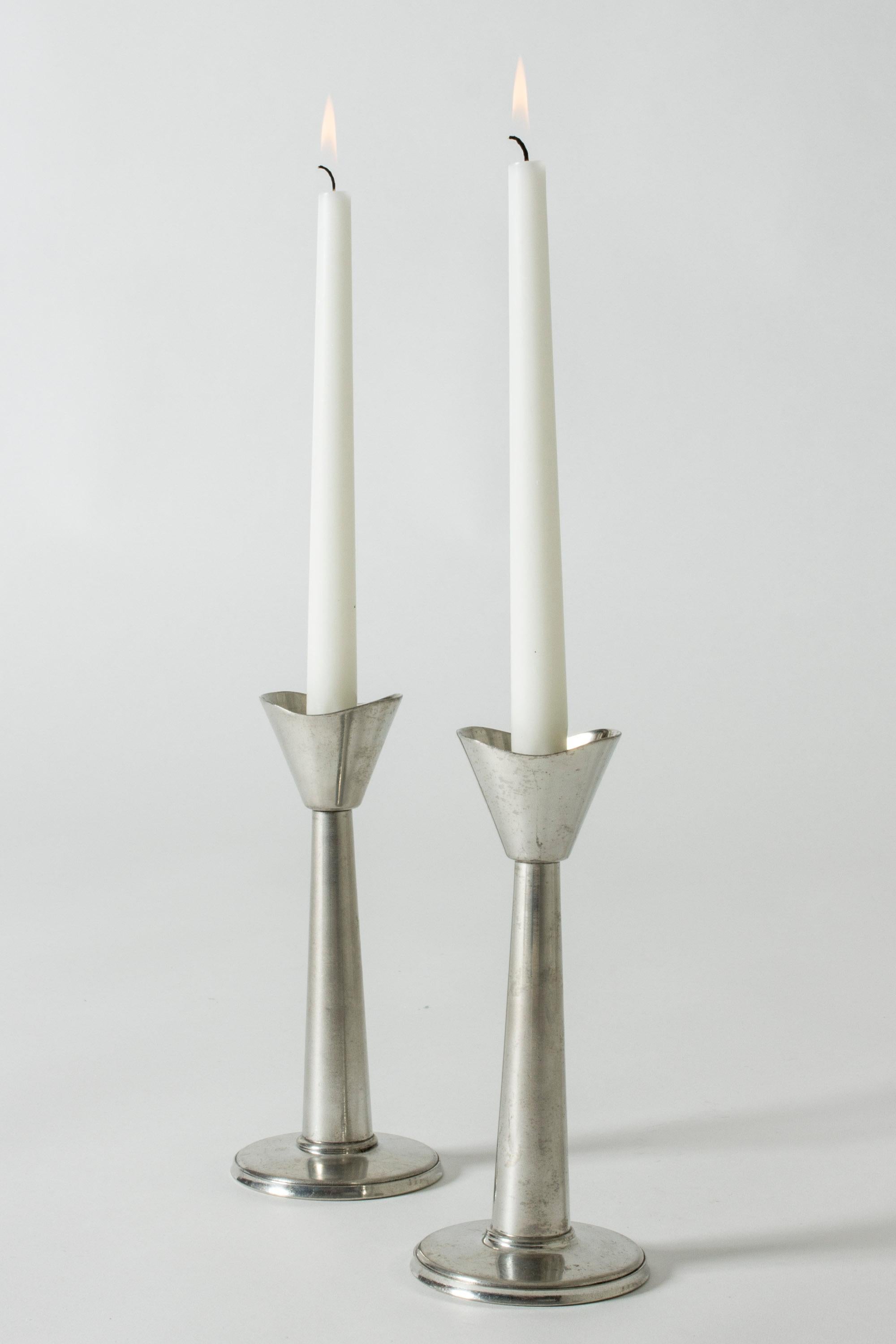 Pair of pewter candlesticks from GAB, in a sleek, functionalist design. Fit regular candles.