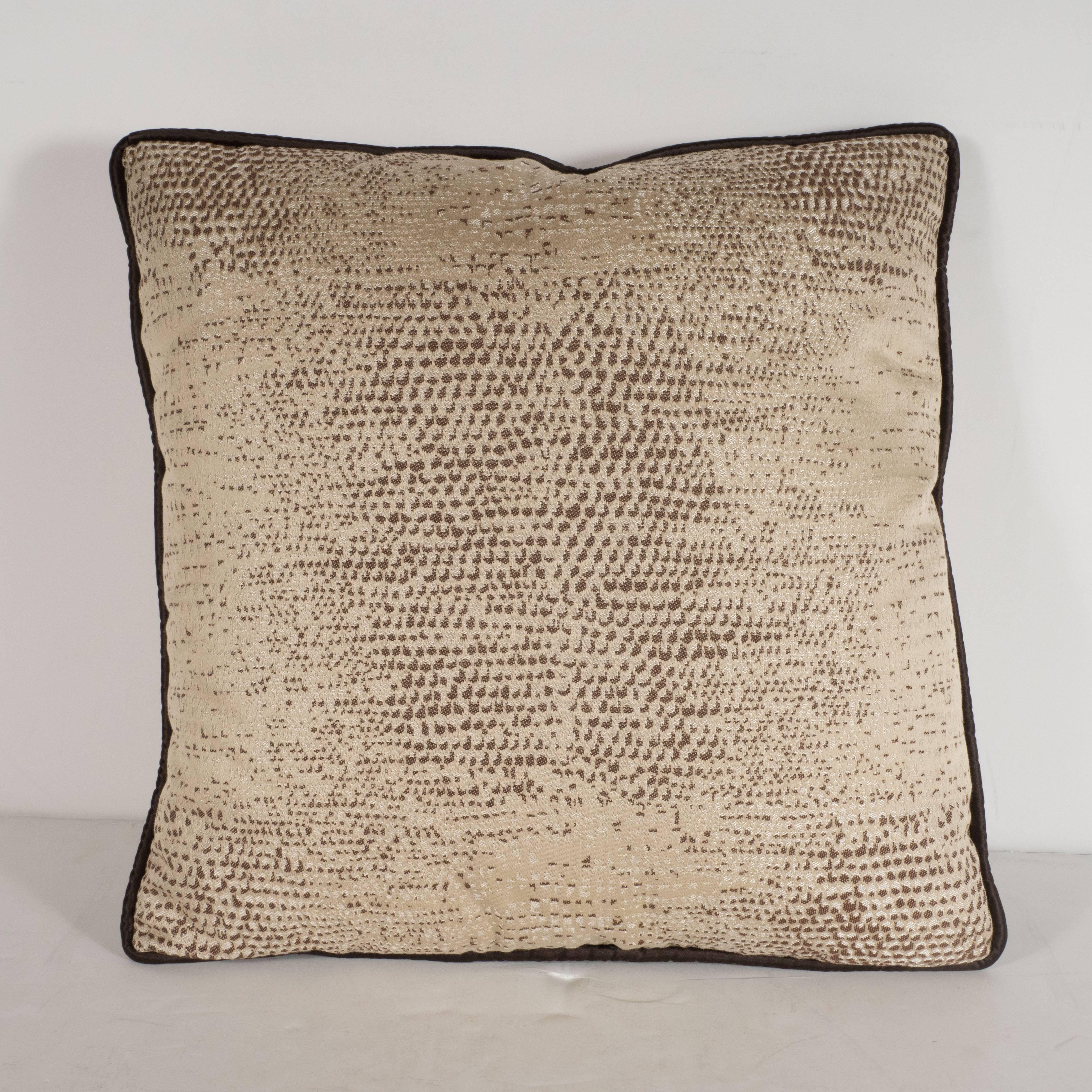 This sophisticated pair of modernist pillows feature an enlarged and stylized lizard print pattern in hues of dark chocolate, coffee and tan set against an ecru background. With their neutral pattern and dynamic pattern, these pillows would be a