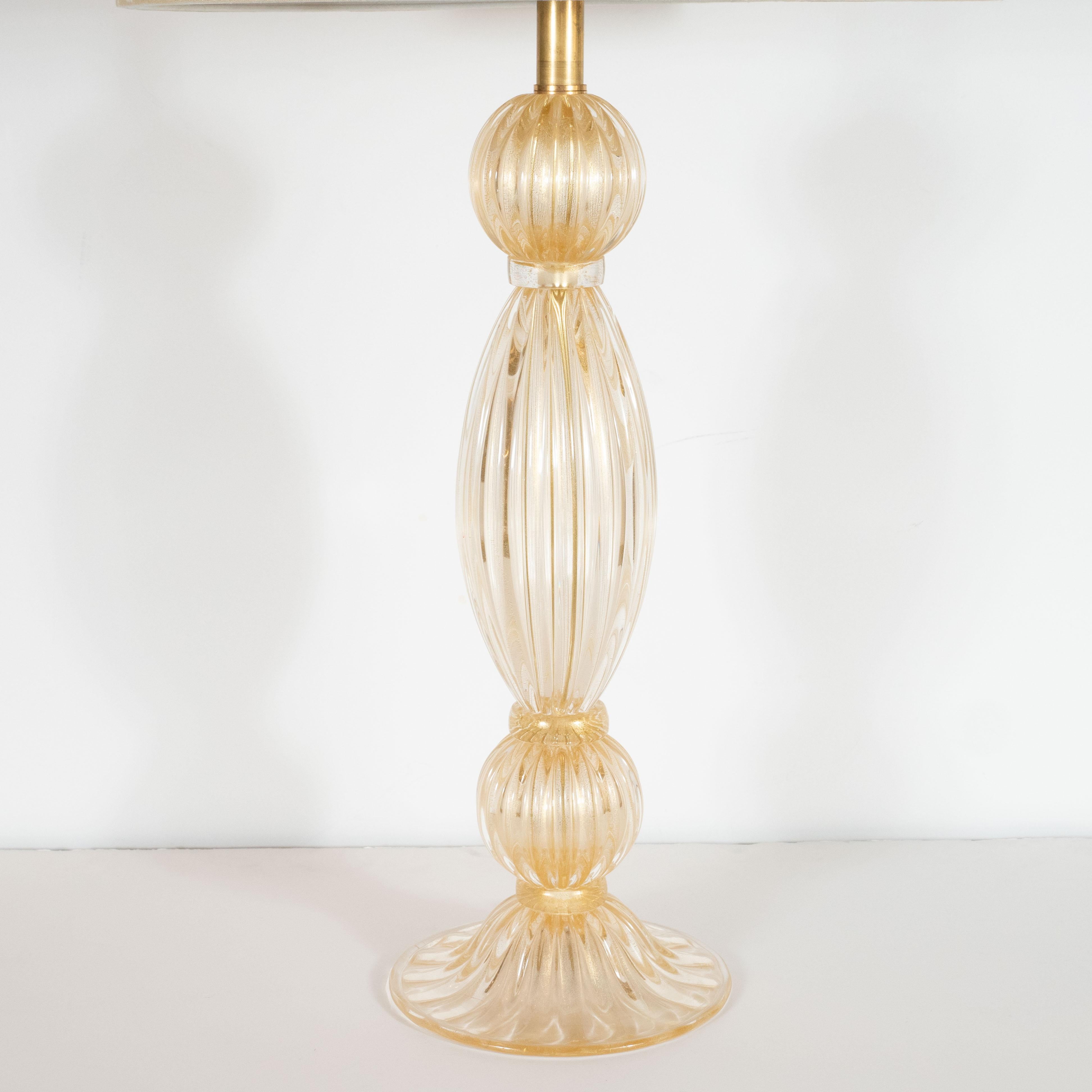 This stunning pair of table lamps were hand blown in Murano, Italy- the island off the coast of Venice renowned for centuries for its superlative glass production. They feature tear drop form bodies in hand blown translucent reeded glass framed on