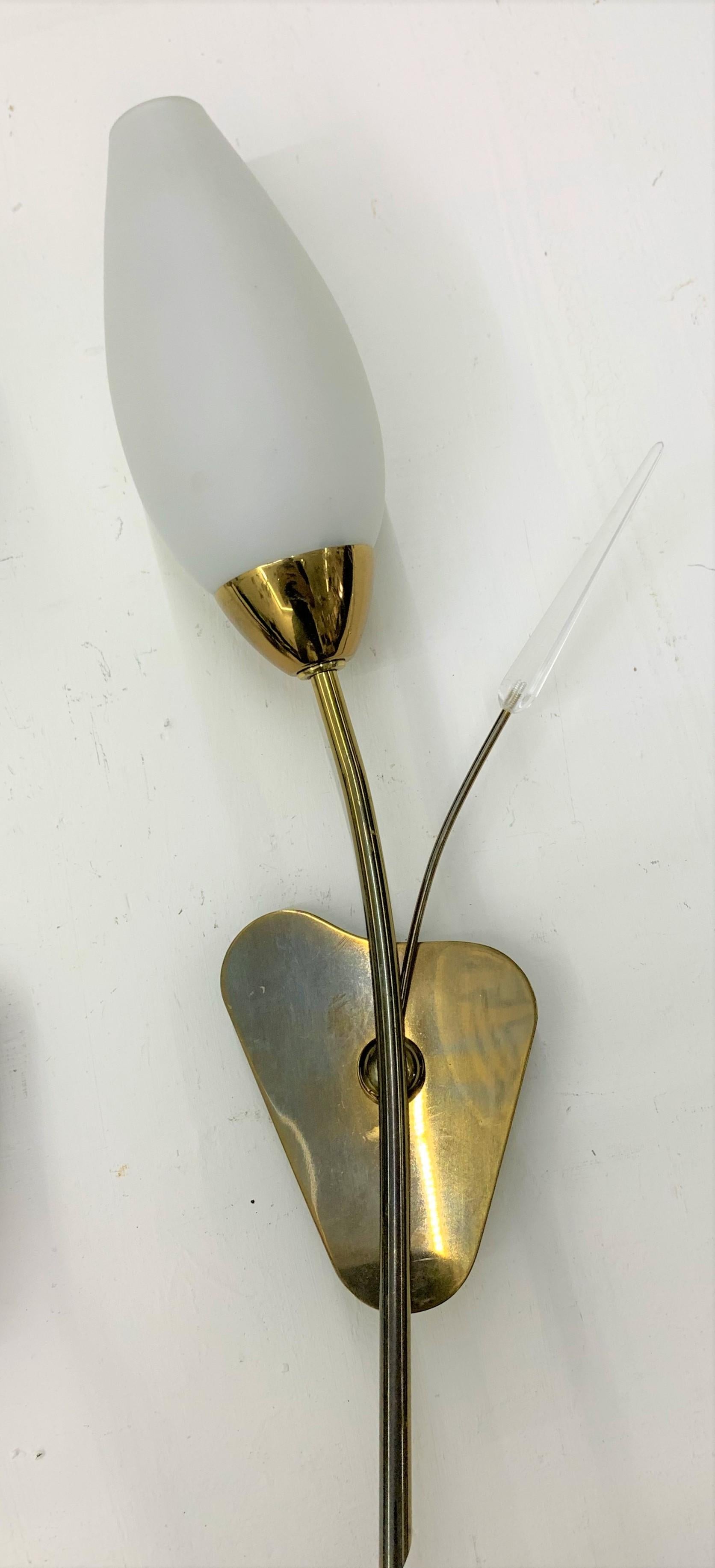 Pair of Mid-Century Modern sconces or wall lights attributed to Maison Arlus in brass, Lucite and opaline glass.
Made in France, circa 1950s.
 