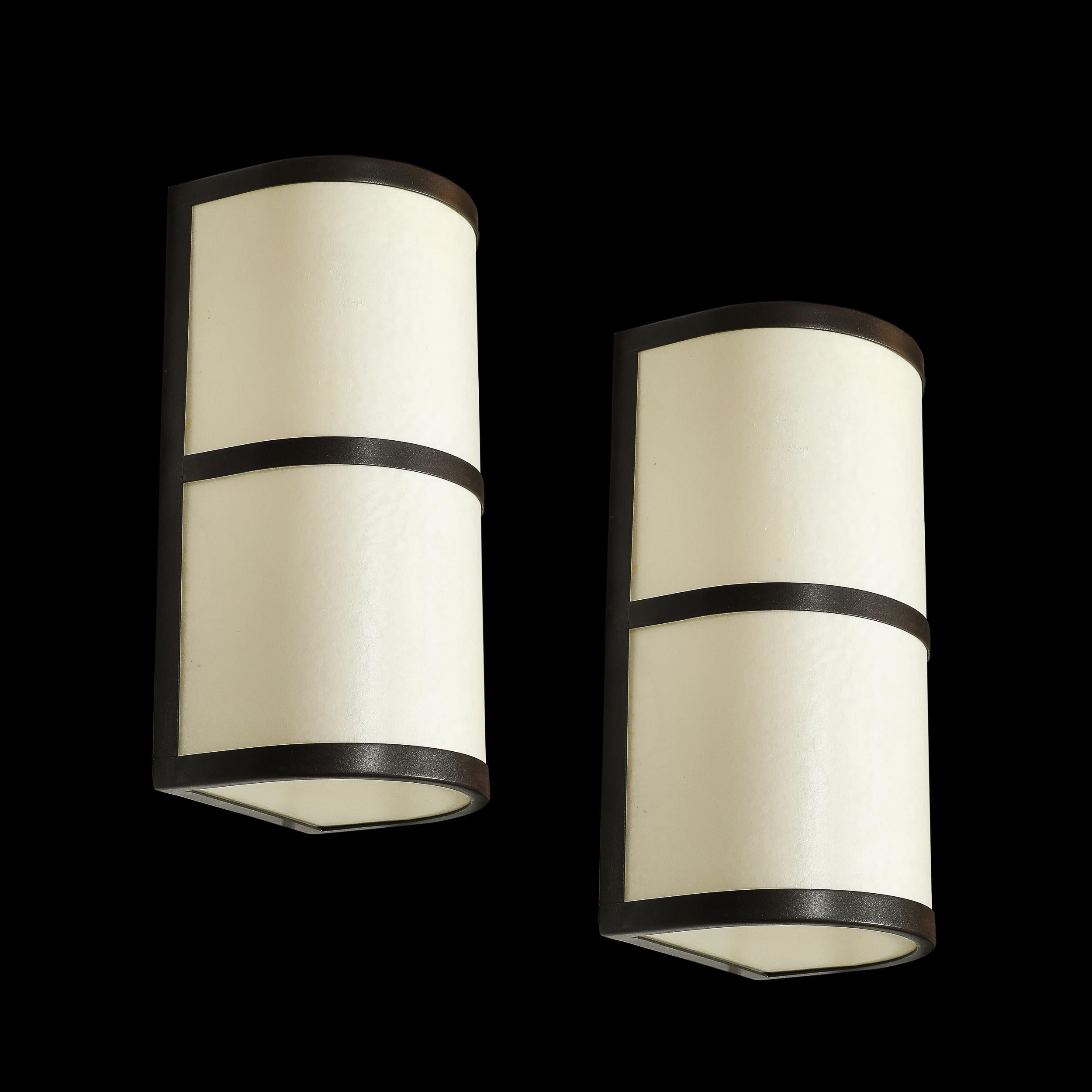 Introduci un tocco di raffinata eleganza nella tua casa con questa coppia di sconsole moderniste, realizzate in Vellum e bronzo oliato e firmate da John Wigmore. Realizzate in America nel XX secolo, queste applique riflettono un'accurata miscela di