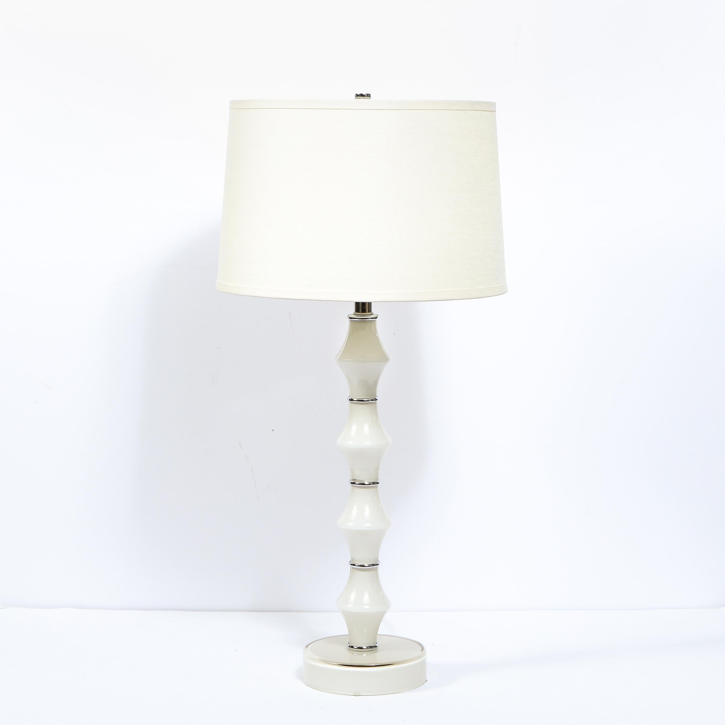 This elegant pair of table lamps were hand blown in Murano, Italy- the island off the coast of Venice renowned for centuries for its superlative glass production. They feature sculptural bodies consisting of four concavely curved pearl white glass