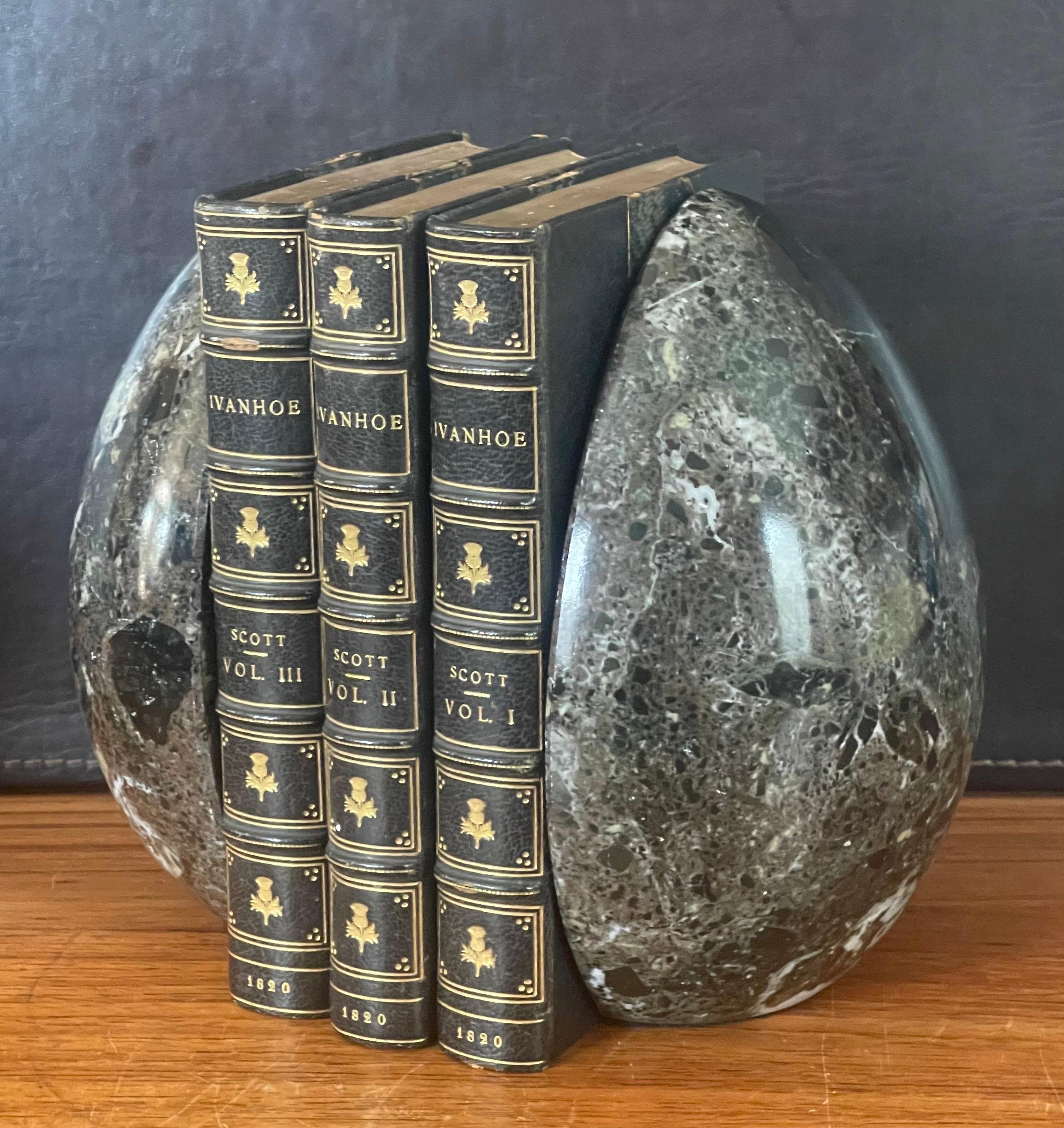 Stunning pair of modernist solid marble egg shaped bookends, circa the 1980s. The pair has a sharp 