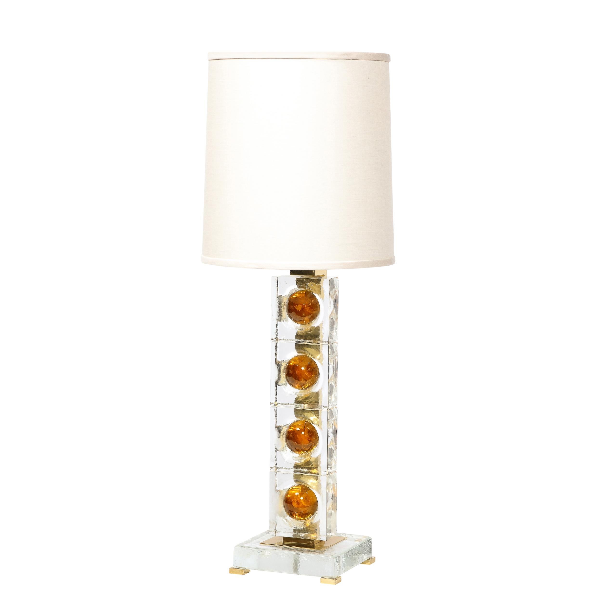 This stunning pair of modernist table lamps were hand blown in Murano, Italy- the island off the coast of Venice renowned for centuries for its superlative glass production- during the latter half of the 20th century. They feature volumetric
