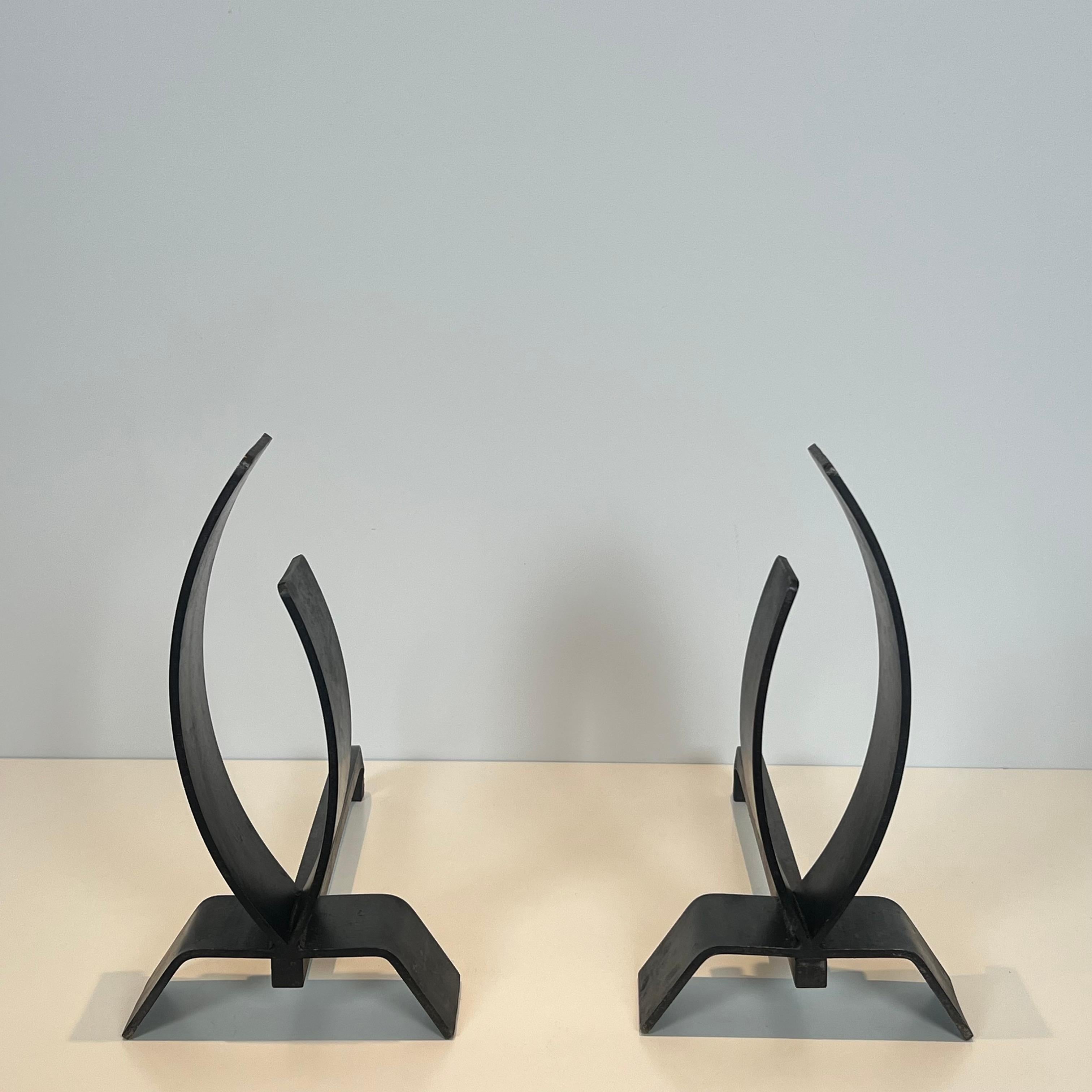 This nice pair of modernist andirons is made of steel and iron. This is a French work. Circa 1970