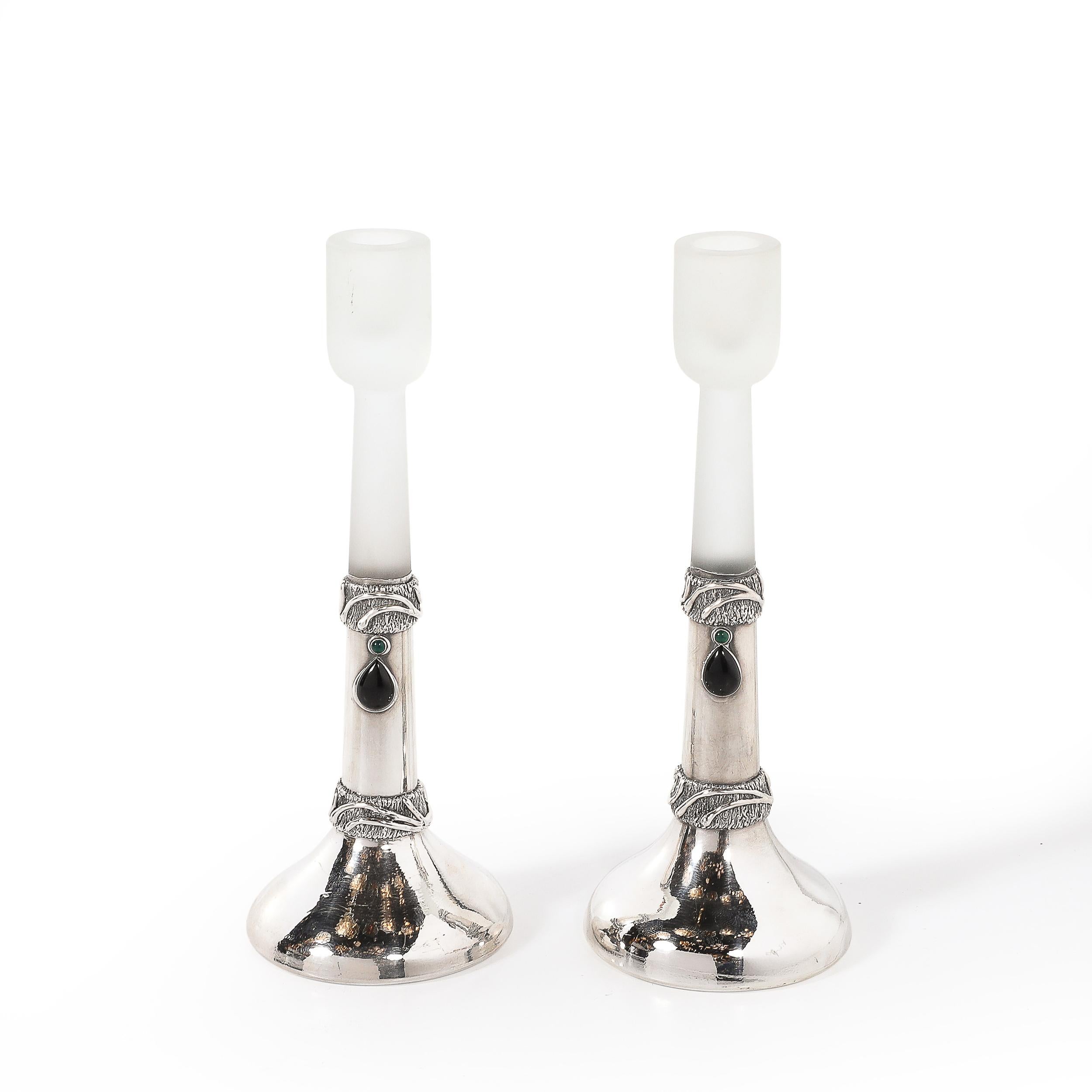 This extraordinary pair of sterling silver candle holders by Domar, crafted in Israel circa 1980, blends modernist sophistication with organic artistry. The sterling frames are adorned with hand-hammered detailing, adding depth and texture to their