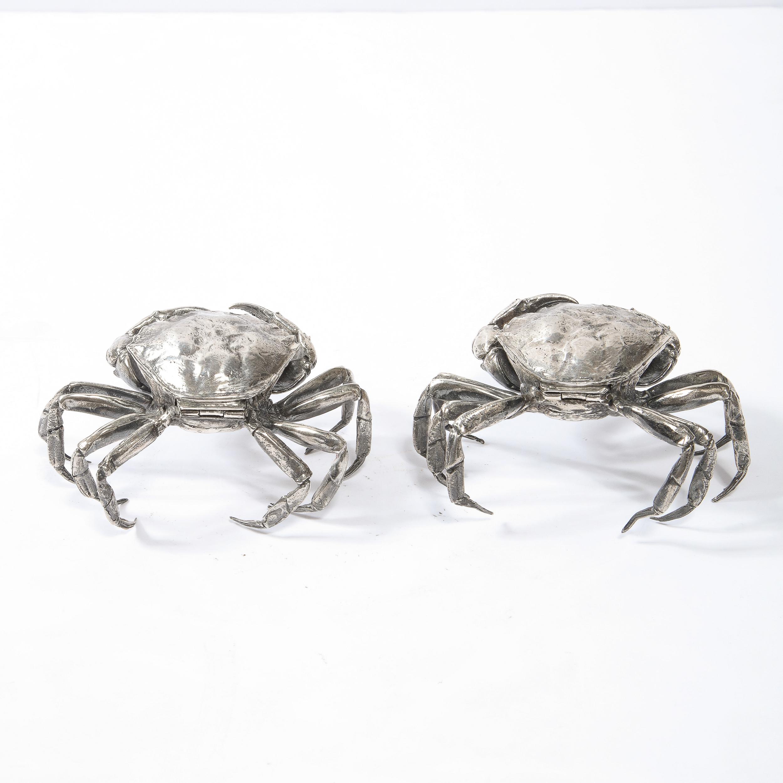 This stunning pair of modernist salt cellars was realized in Italy during the latter half of the 20th century. They offer stylized crab forms hand wrought in sterling silver, each offering eight legs and two claws with a lidded body that opens to