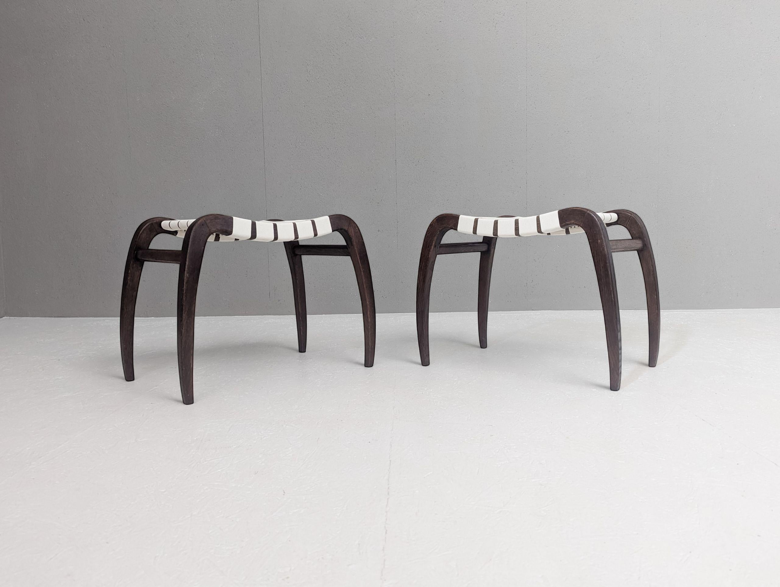 Designed in 1946 by Czech architect Ladislav Bartoníček, this pair of modernist stools exemplifies the thoughtful intersection of functionality and craftsmanship that defined postwar Czechoslovak design. Created for Krásná jizba, the design-focused