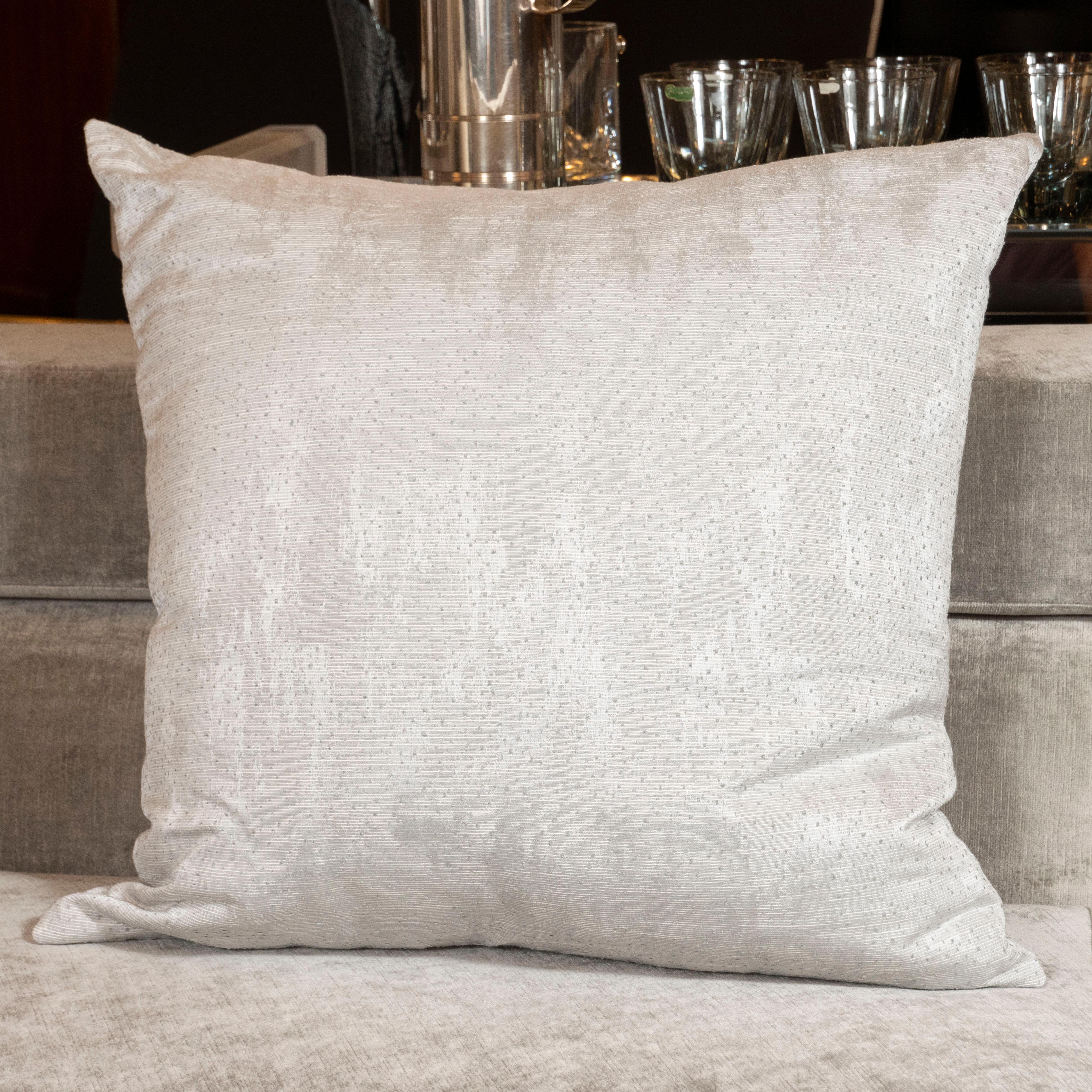 This refined pair of modernist pillows were realized in the United States during the 21st century. They feature an organic striated pattern with miniature dotted tufts in dove gray against a lighter powder gray accent. With their monochromatic