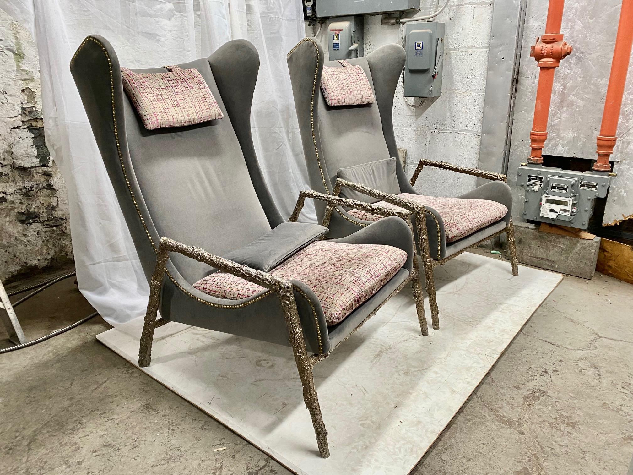 Pair of modernist velvet and bronze wingback armchairs with bronze structure.