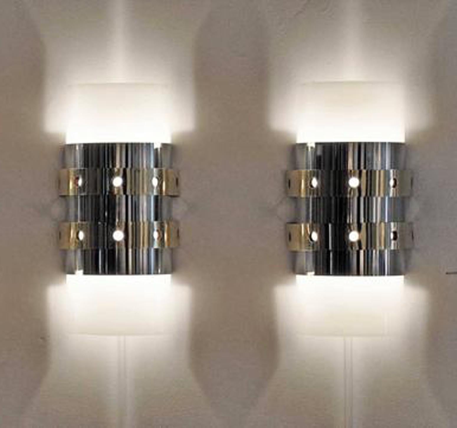 Pair of modernist, 1970s acrylic, polished chrome, and brass wall sconces.
Rewired and ready for use. Price is for the pair.