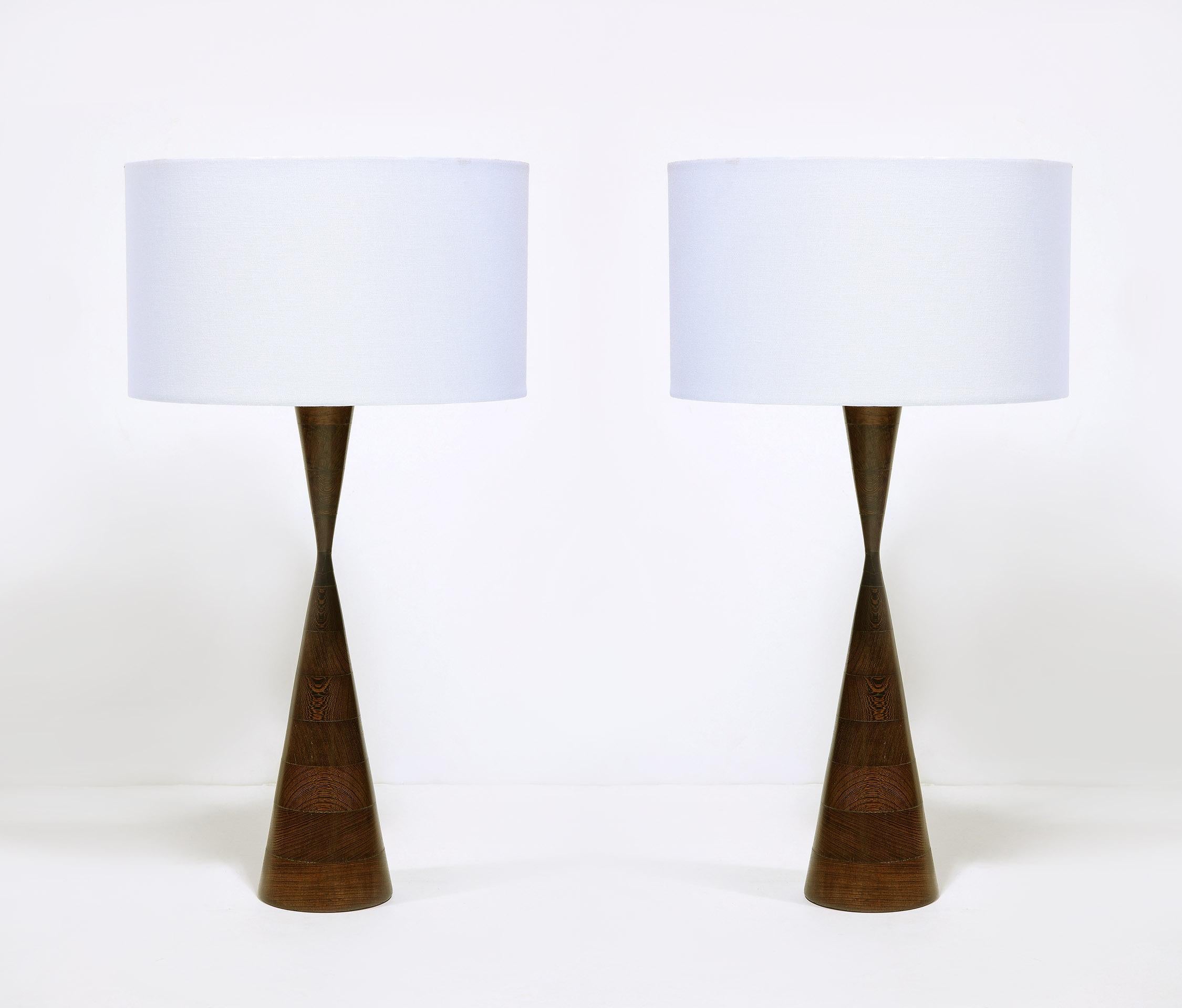 The stacked and turned Wenge wood lamps of unusual design. 
In the style of Phillip Lloyd Powell.