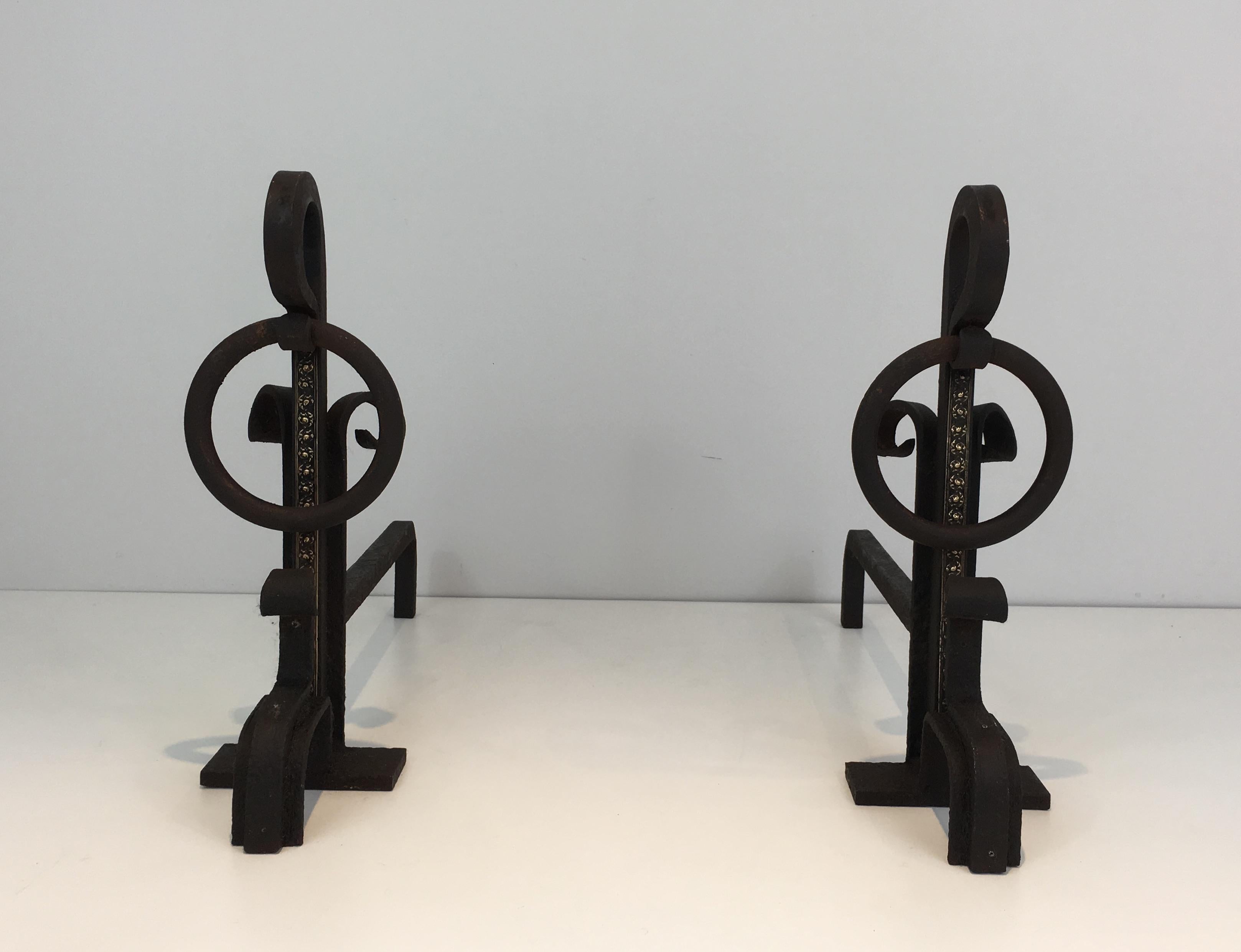This pair of modernist andirons is made of wrought iron with a brass decoration on the front. This is a French work. Arts & Crafts, circa 1900.