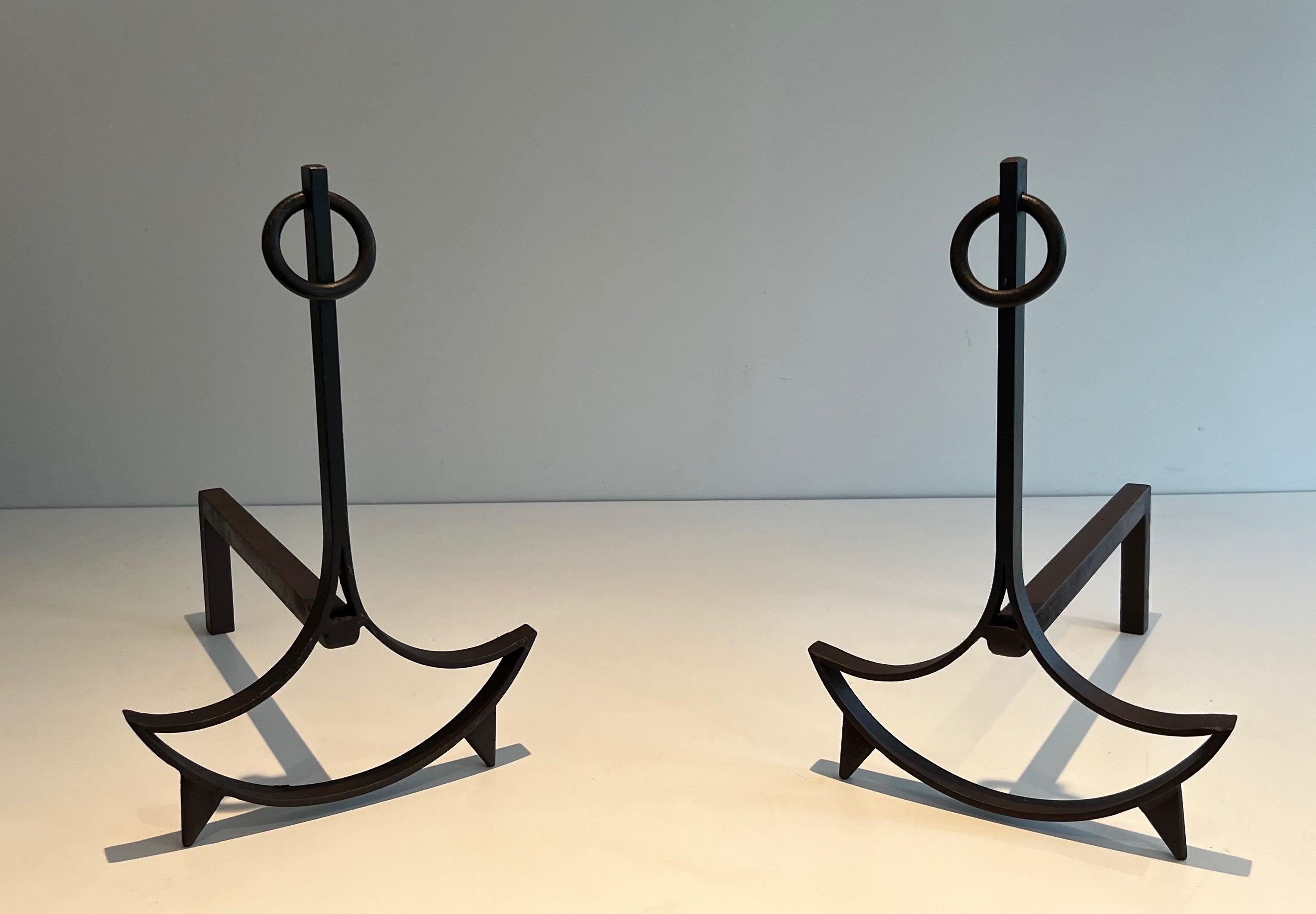This nice pair of modernist andirons is made of wrought iron. This is a French work. Circa 1940