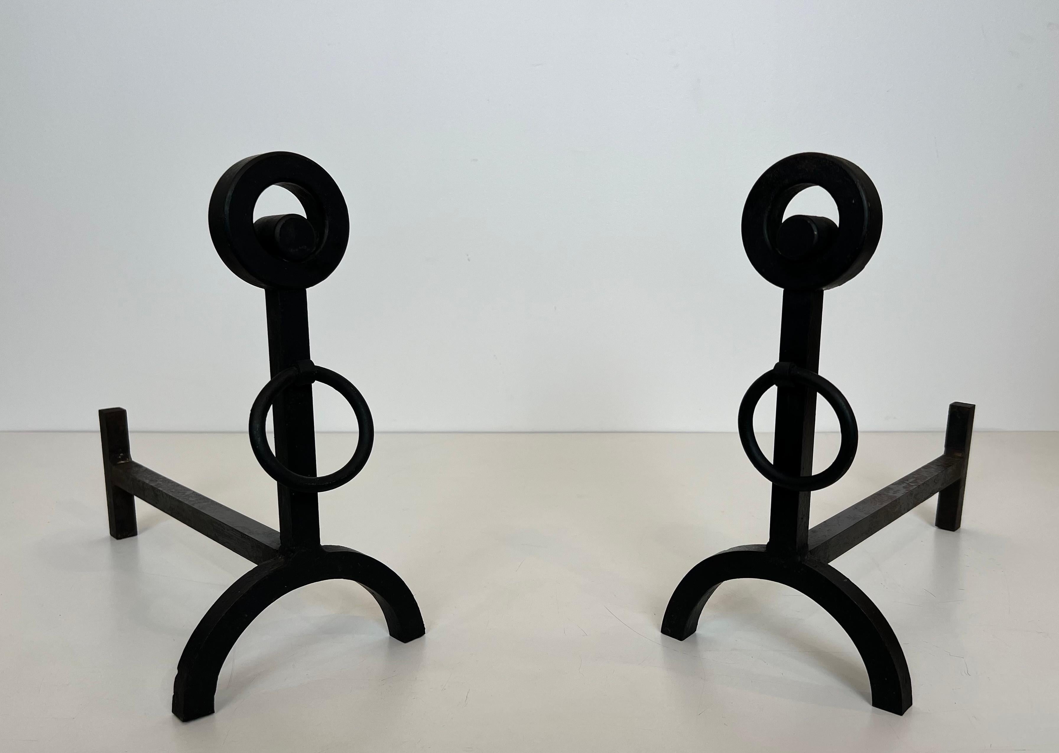 This very nice pair of modernist andirons is made of wrought iron. This is a French work. Circa 1970.