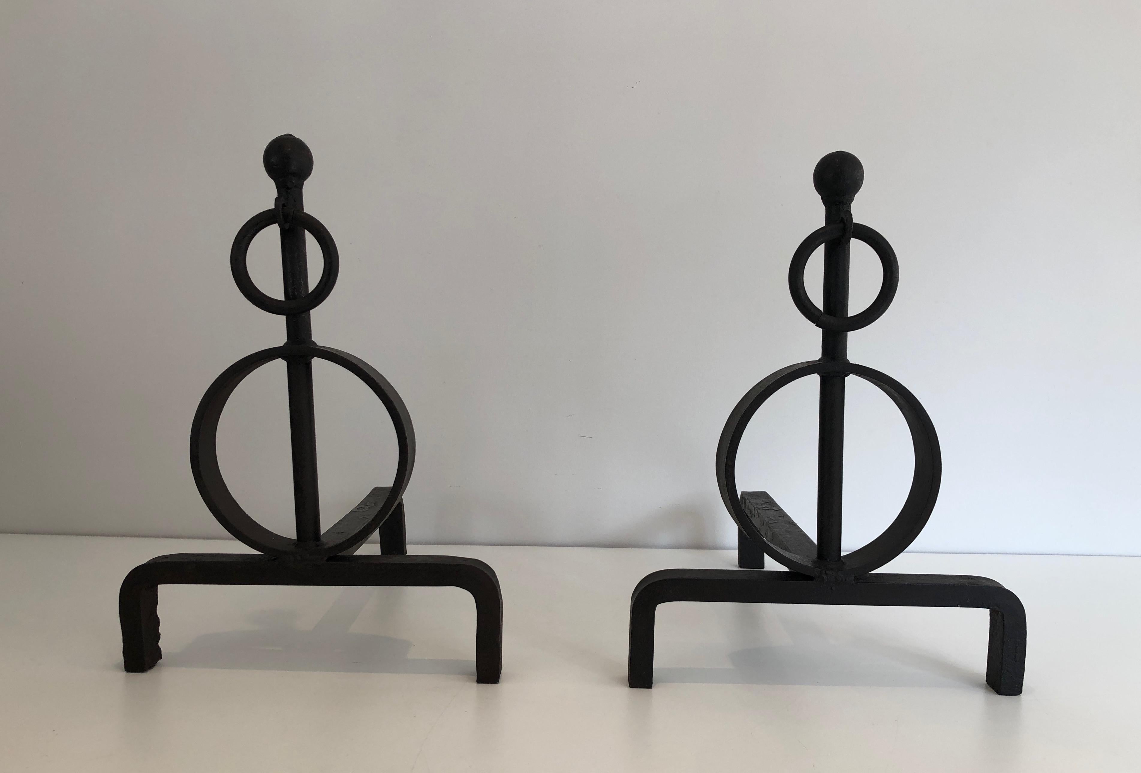 This pair of modernist andirons is made of wrought iron. This is a French work, circa 1970.