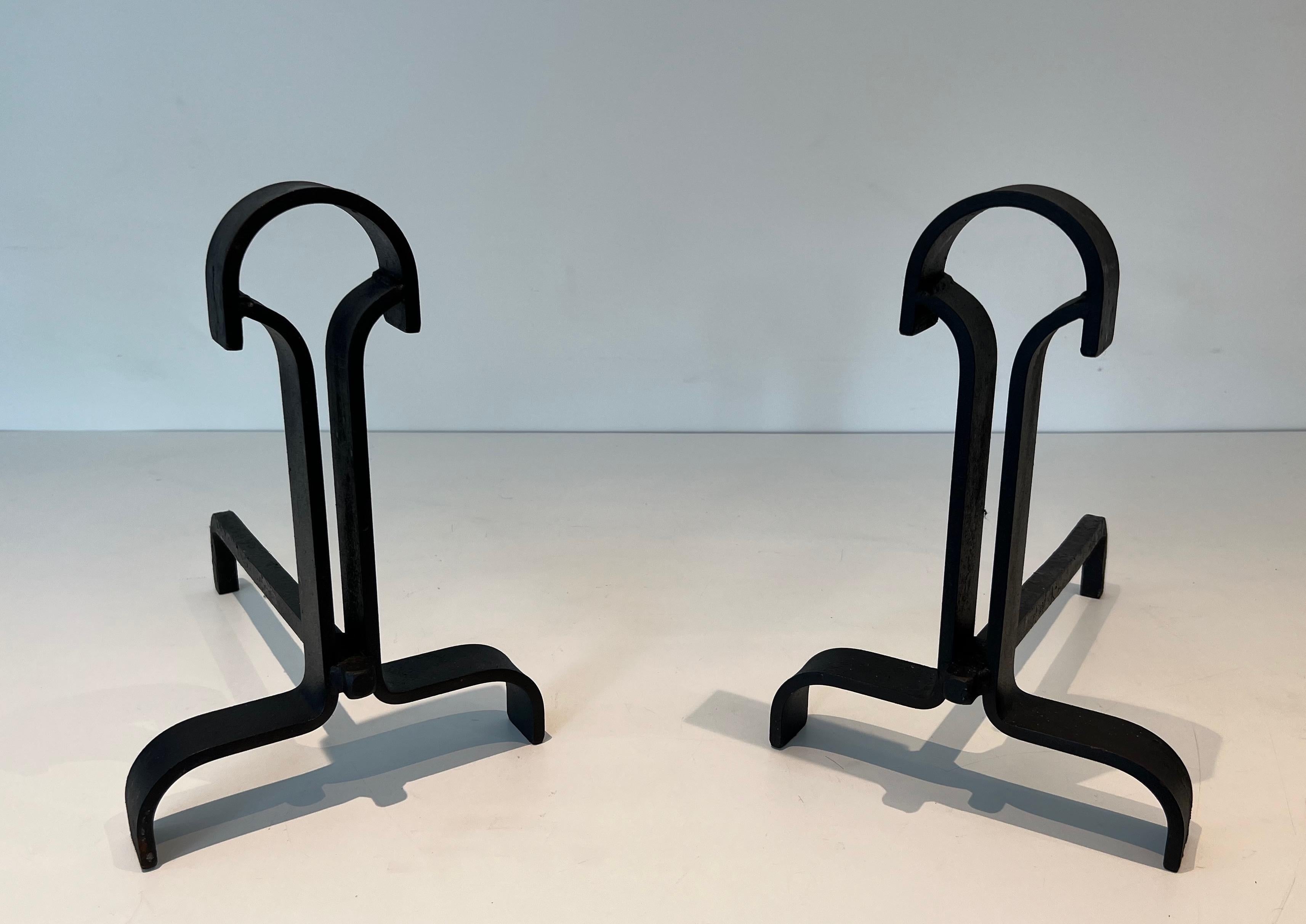This nice and unusual pair of modernist andirons is made of wrought iron. This is a French work. Circa 1940