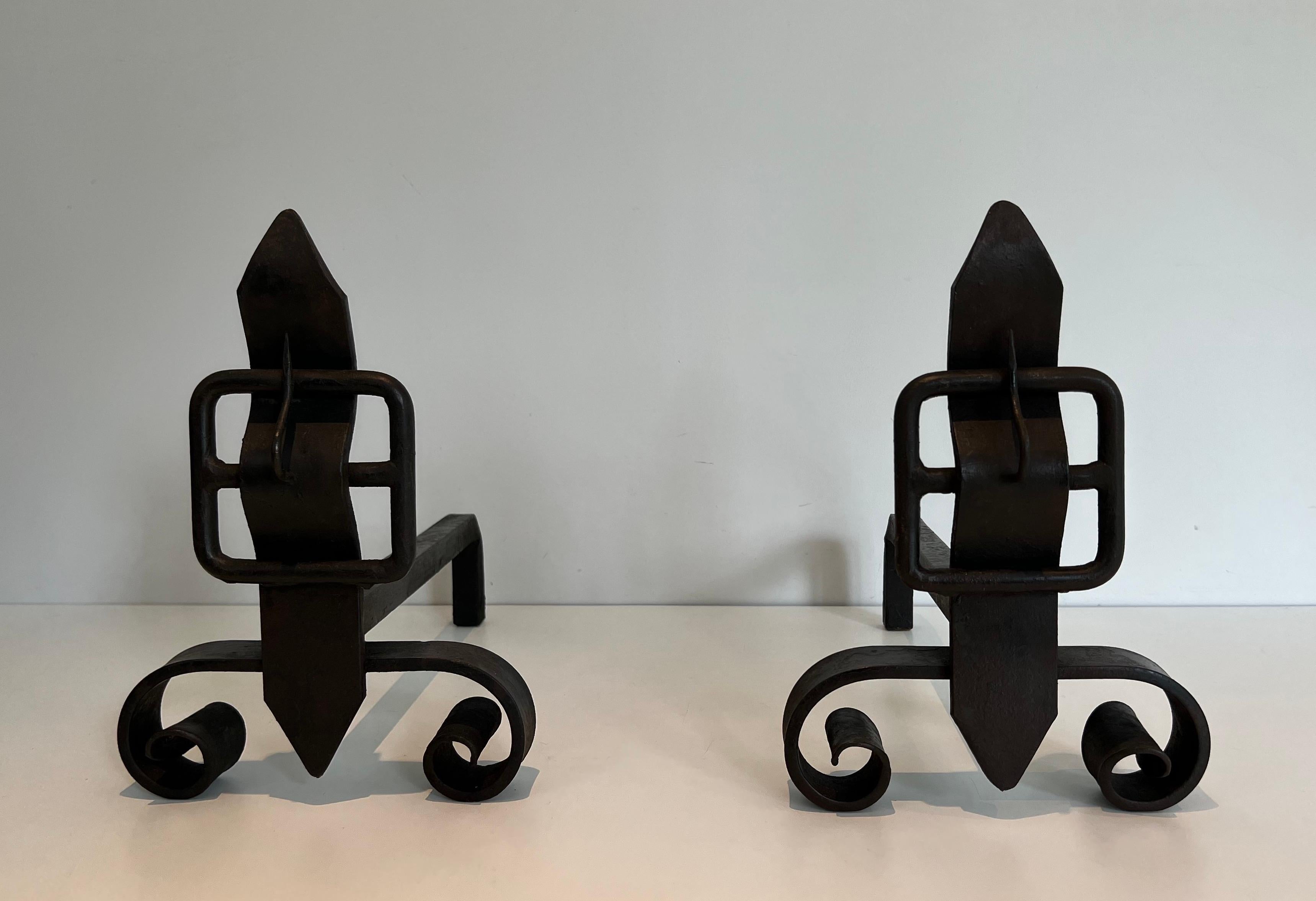 This pair of andirons representing a belt is made of wrought iron. This is a French work. Circa 1950.