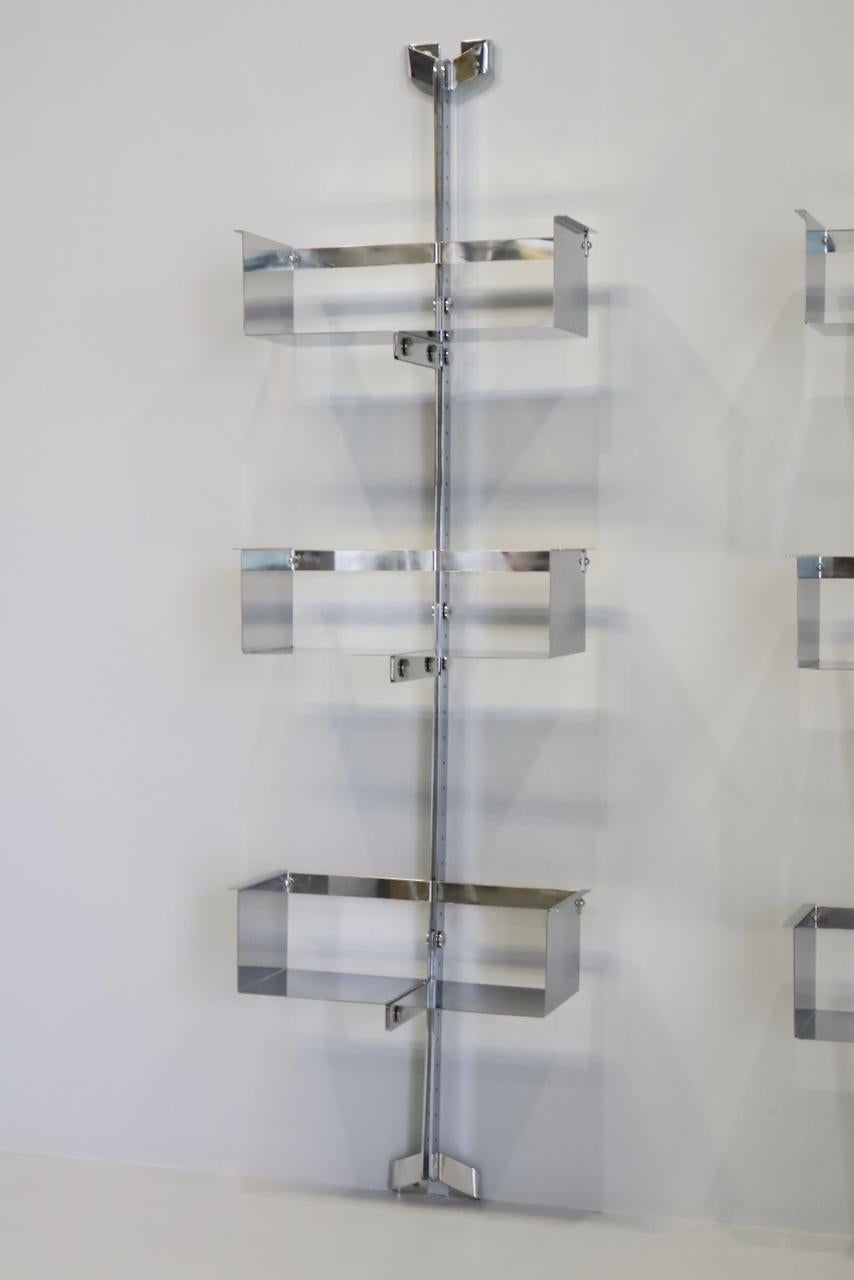 Pair of modular wall-mounted shelving system designed by Vittorio Introini, produced by Saporiti, Italy, circa 1969.  Stainless steel, very good condition. Shelves can be used individually or combined together in many different ways 3 shelves for